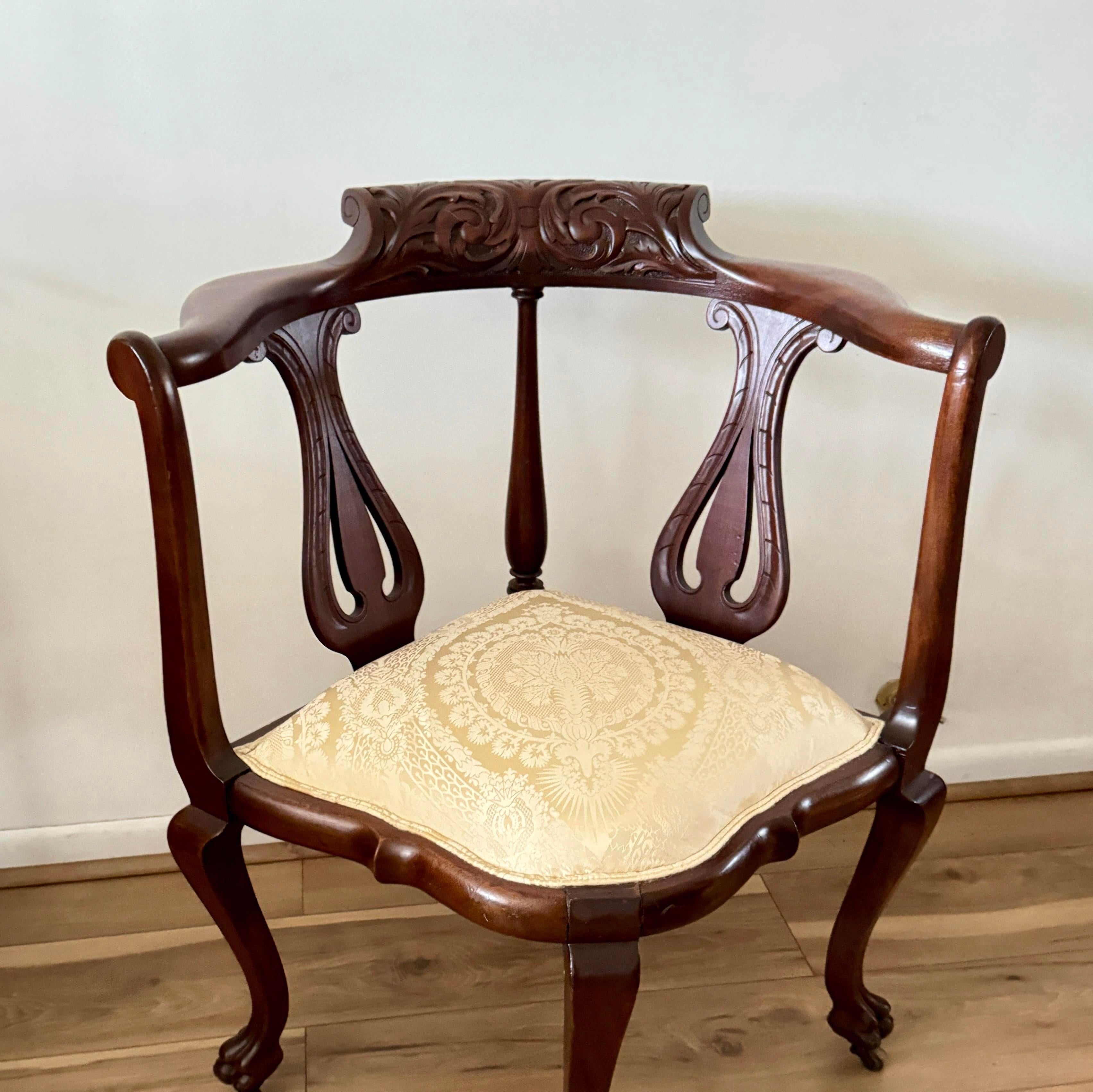 This exquisite piece showcases meticulous craftsmanship with its beautiful carved details, seamlessly blending the sophistication of Chippendale design with the warmth of rich mahogany wood. The chair's intricate carvings add a touch of opulence,