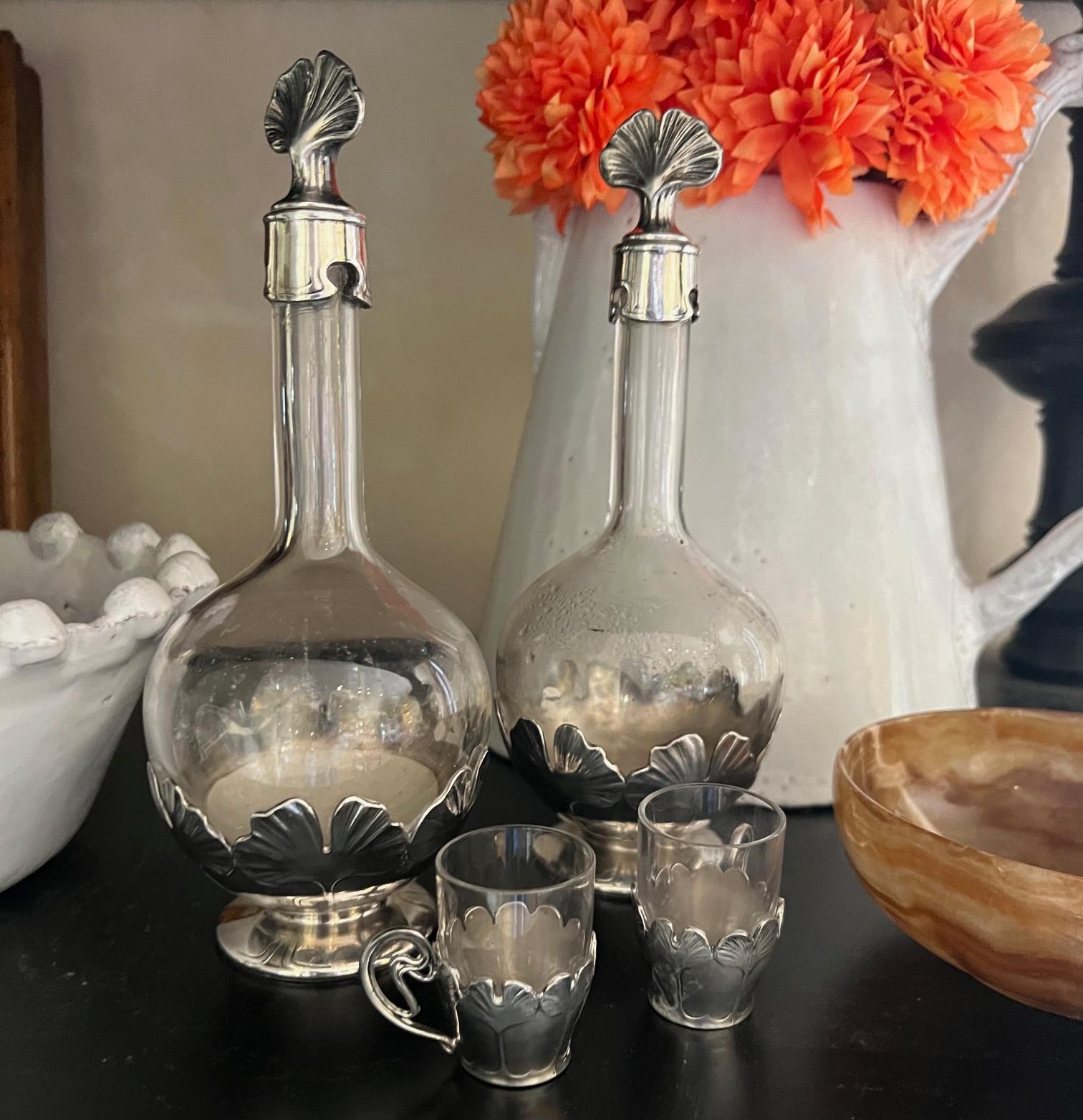 Set of two decanters with stoppers and a set of six glasses with casing from Christofle for its Gallia line, made in France in the early part of the 20th century. The line was created for beautifully designed pieces from the French Art Nouveau and