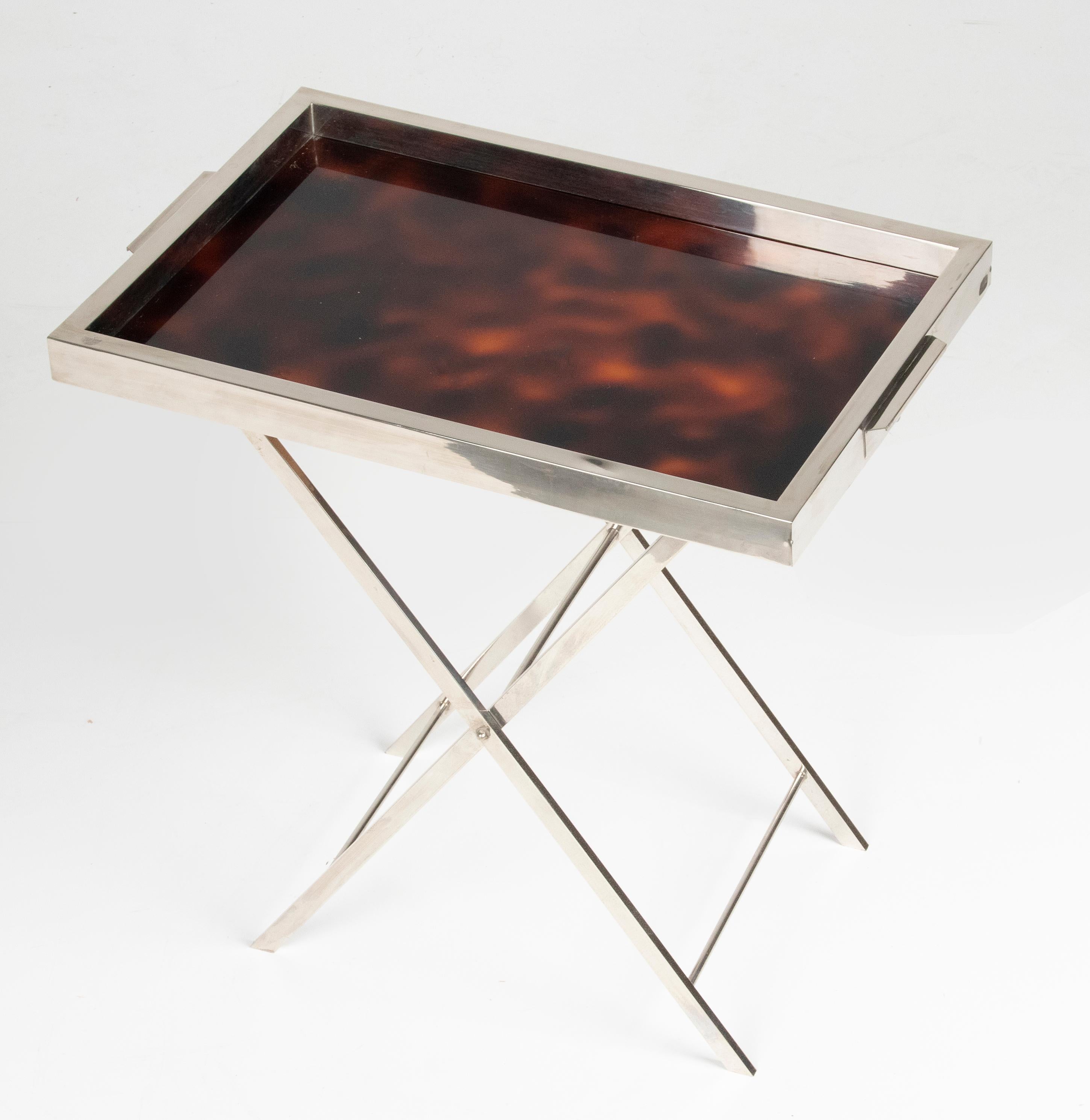 Beautiful serving table from the French Art Deco period. The table has a sleek design, and a beautiful combination of shiny chrome and imitation tortoiseshell. The base of the table is foldable, so only the tray can be used as well. Point of