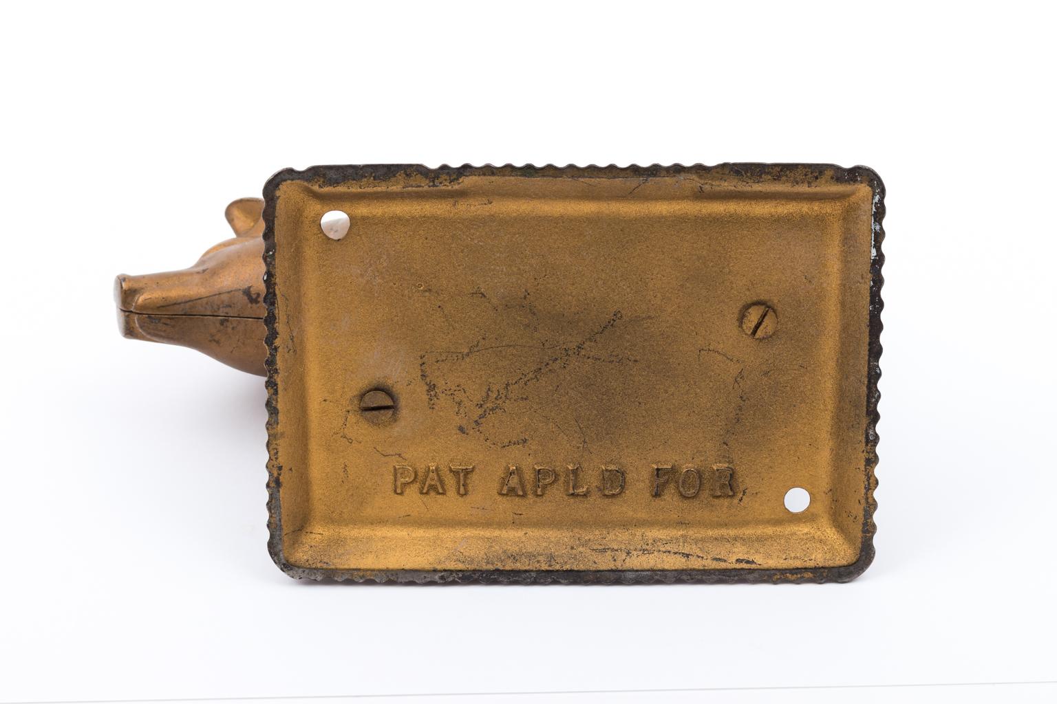 Counter top cigar cutter in the shape of a cast iron pig, possible made to advertise Morey's Fat Hog Cigars. The cigar would go into the butt while the tail is used to trim the cigar. Please note of wear with age to the finish. Most of the tail is