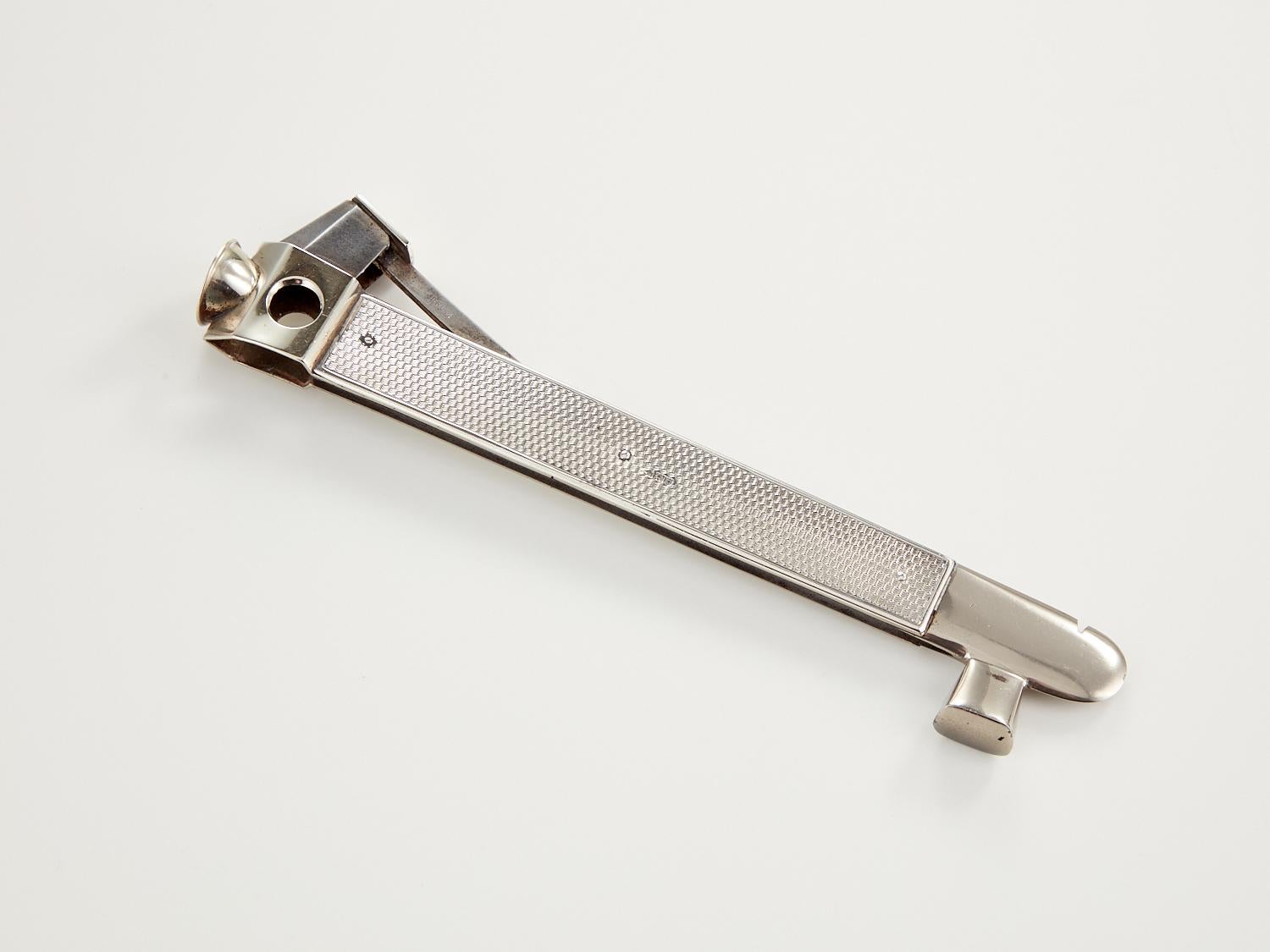 An Early 20th Century Cigar Cutter with silver mounts, Date London 1913.

This cigar cutter is unusual being 8 1/2” long. It's base metal body is mounted with English silver which dates to London 1913.
This piece is showing signs of ware but still a
