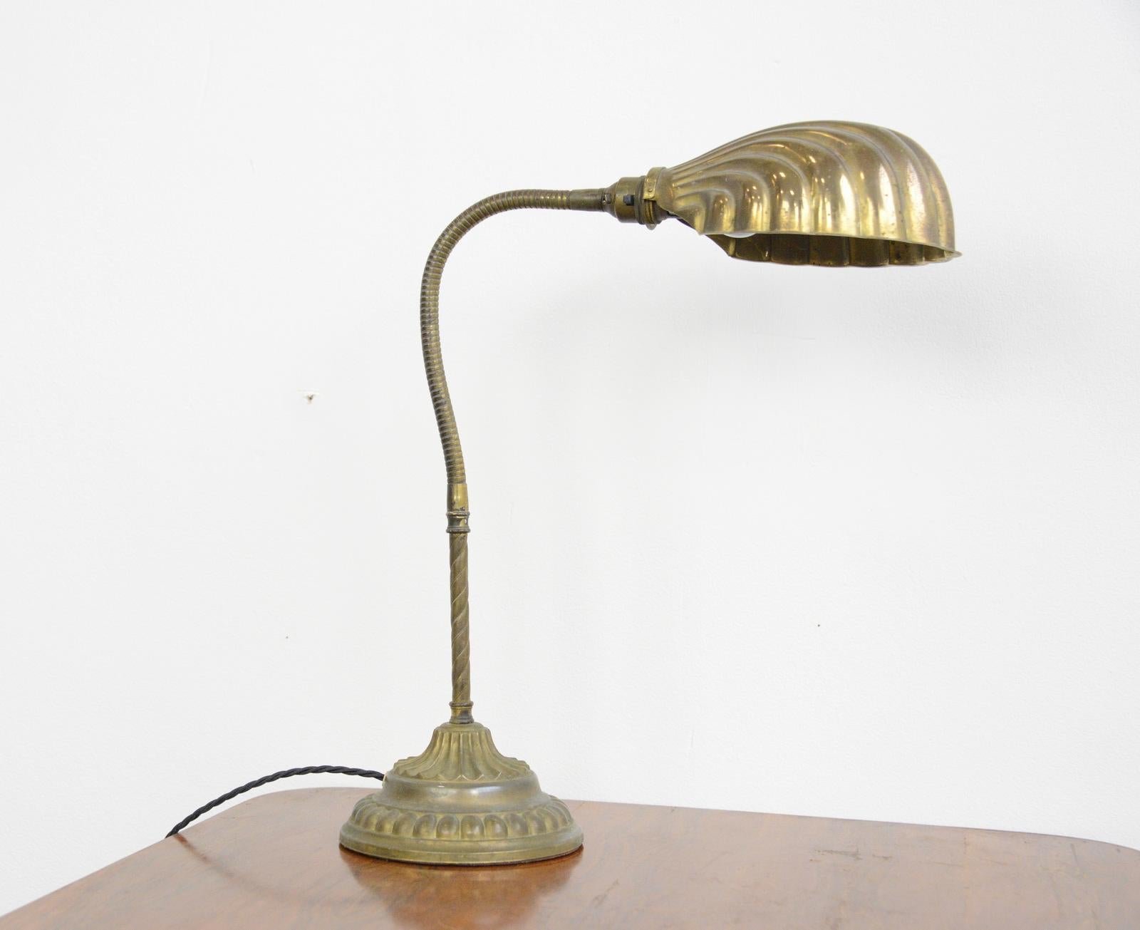Early 20th century clam shell desk lamp, circa 1910

- Solid brass clam shell shade
- Ornate brass base with cast iron insert 
- Barley twist stem
- Takes B22 fitting bulbs
- On/Off switch on the bulb holder
- English, 1910
- Measures: 68cm
