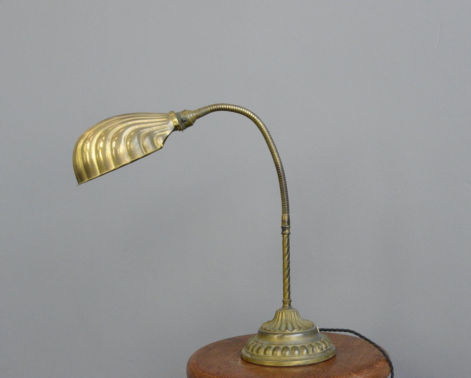 Early 20th century clam shell desk lamp, circa 1910

- Solid brass clam shell shade
- Ornate brass base with cast iron insert 
- Barley twist stem
- Takes B22 fitting bulbs
- On/Off switch on the bulb holder
- English, 1910
- Measures: 68cm