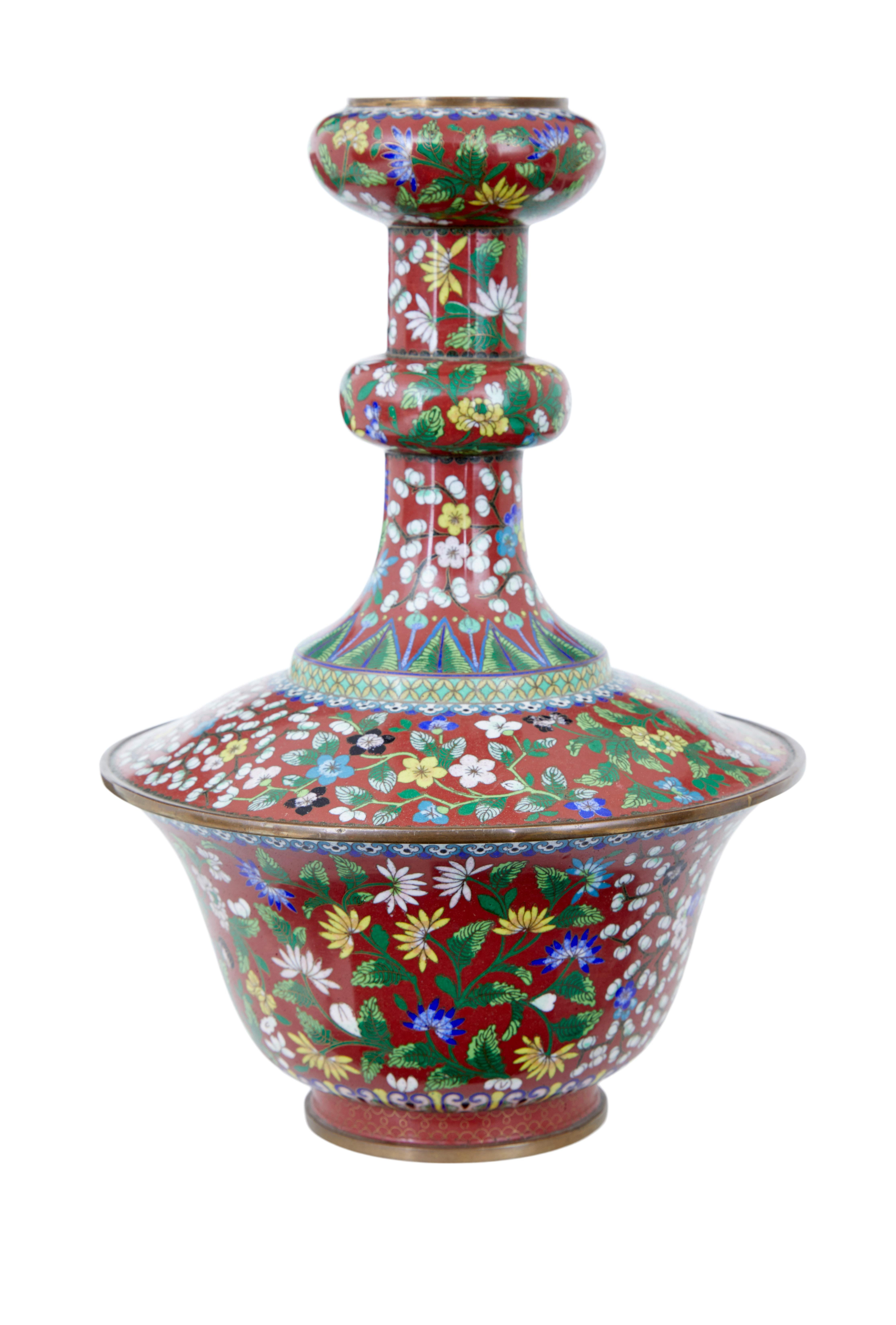Early 20th century cloisonne enamel vase circa 1920.

Decorative Chinese piece of cloisonne.  Decorated with reds, whites, greens and blues around a brass spun main frame.

Missing the lid/stopper, but a lovely decorative item.