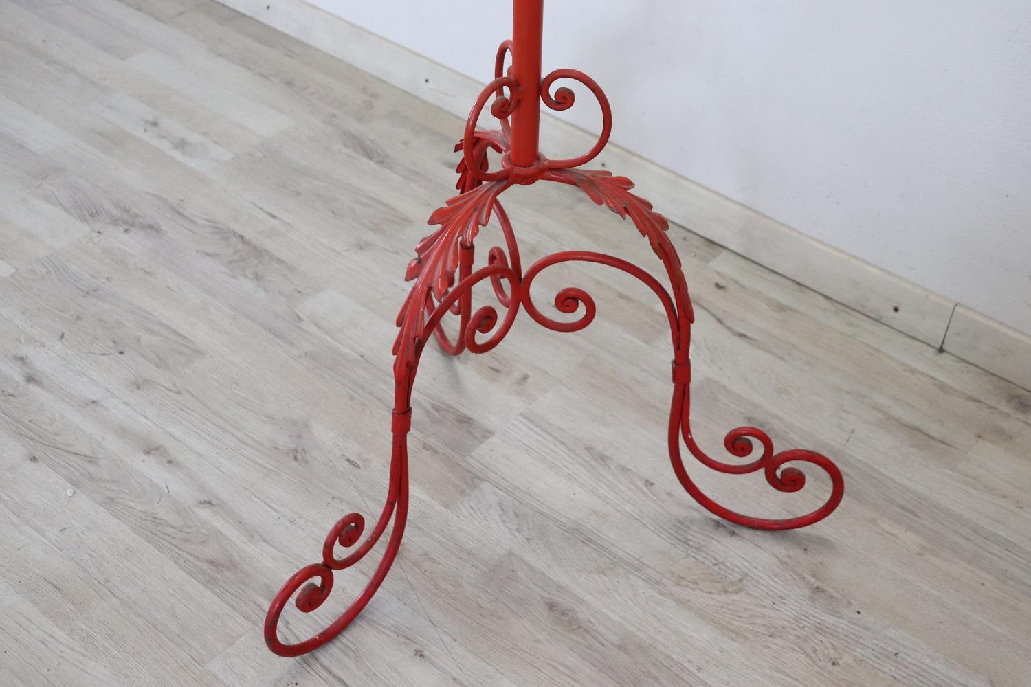 Fantastic Italian vintage clothes hangers in red lacquered iron. Beautiful ironwork with scrolls and curls. Good general conditions.