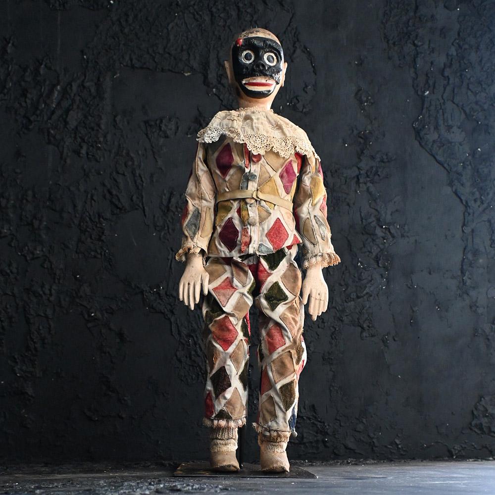 Early 20th century clown puppet.
A charming yet slightly creepy looking early 20th century hand crafted oversized puppet figure. With hand carved wooden body, fully articulated and with an amazing hand carved black wooden masked face with red