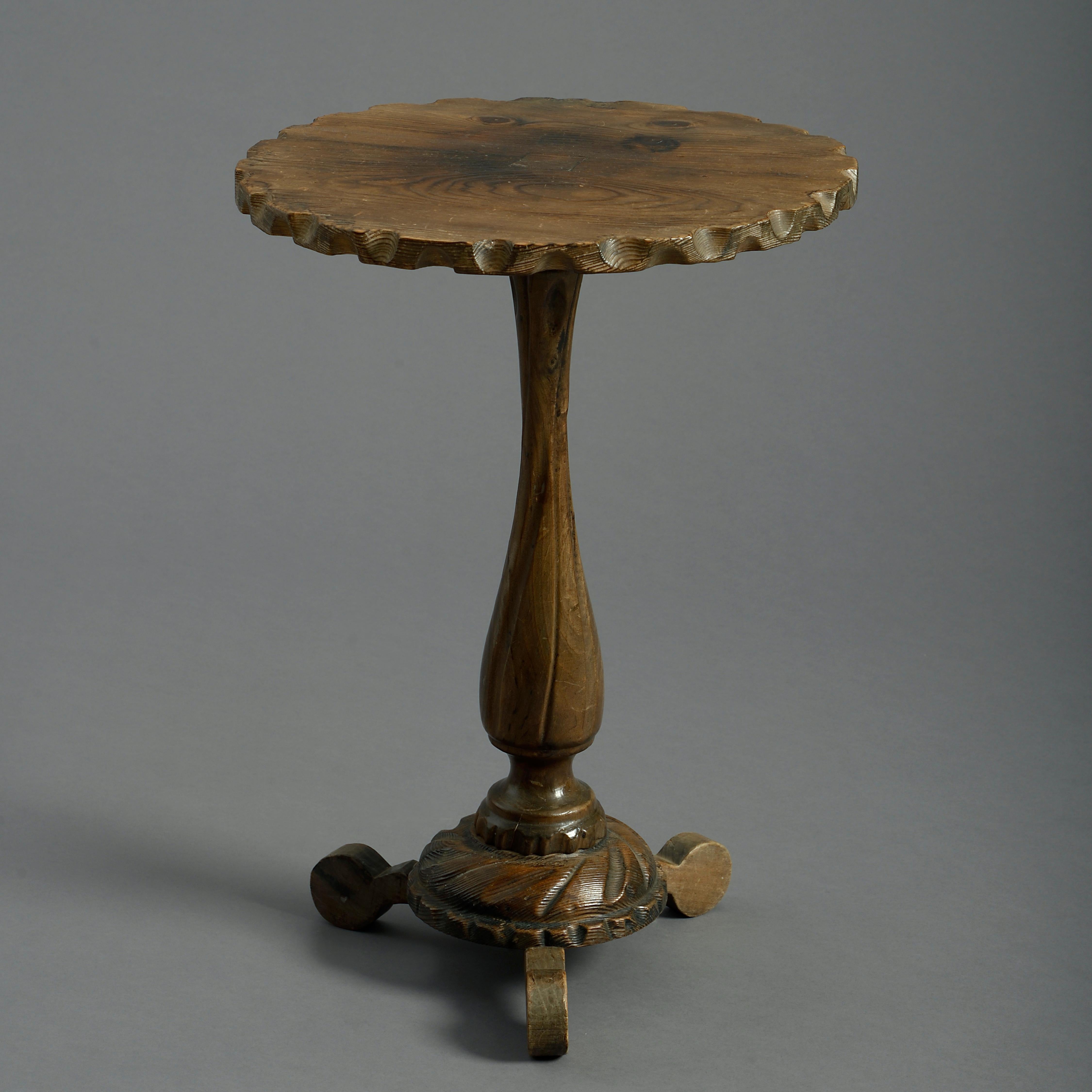 A charming early twentieth century elm occasional table, the cog-shaped top set above a spiral fluted turned stem upon a gadrooned socle, terminating on a tripod base.