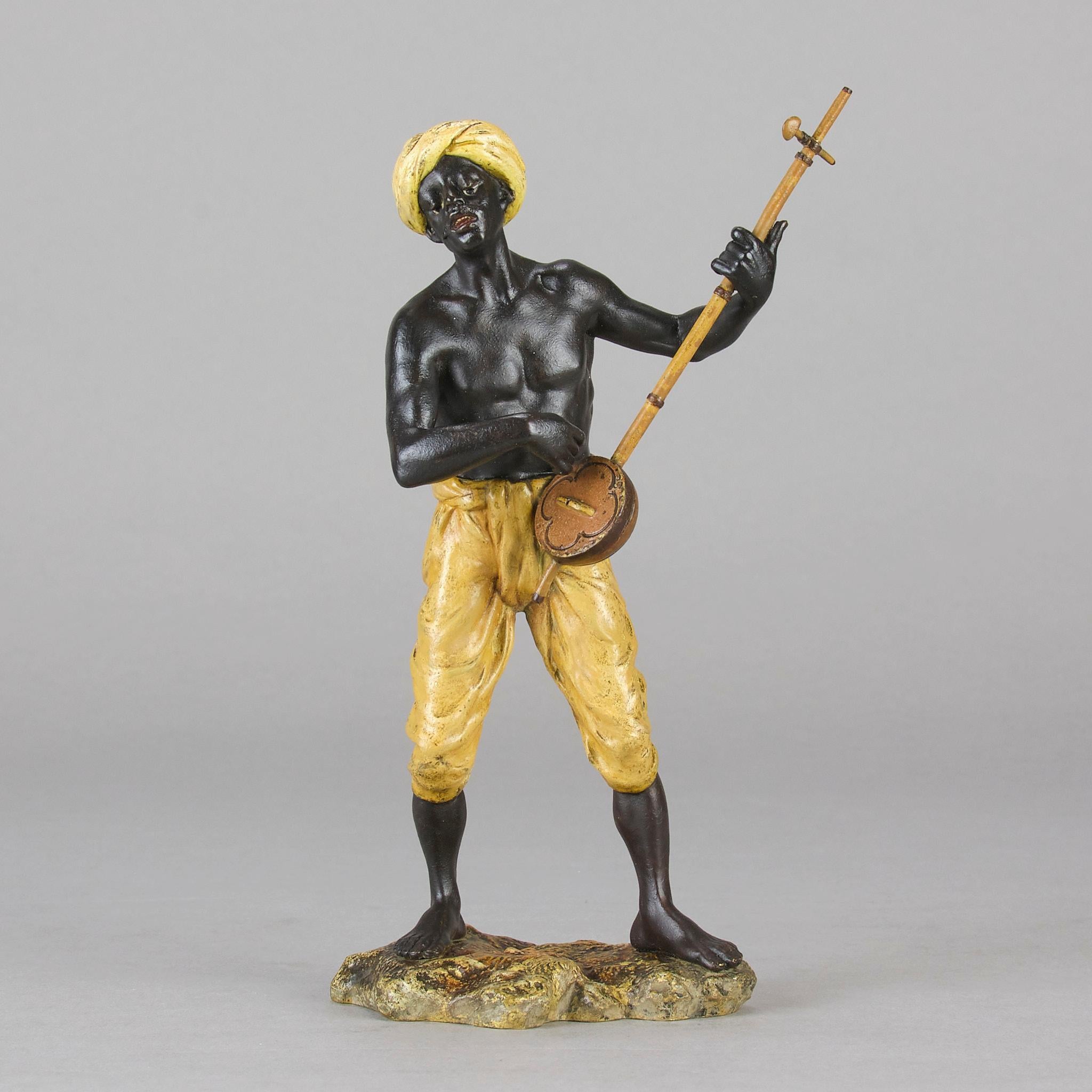 An excellent early 20th Century cold-painted Austrian bronze figure of an young Arab man playing a stringed musical instrument. The bronze with very fine hand chased surface detail and and good naturalistic colour, signed with the Bergman 'B' in an