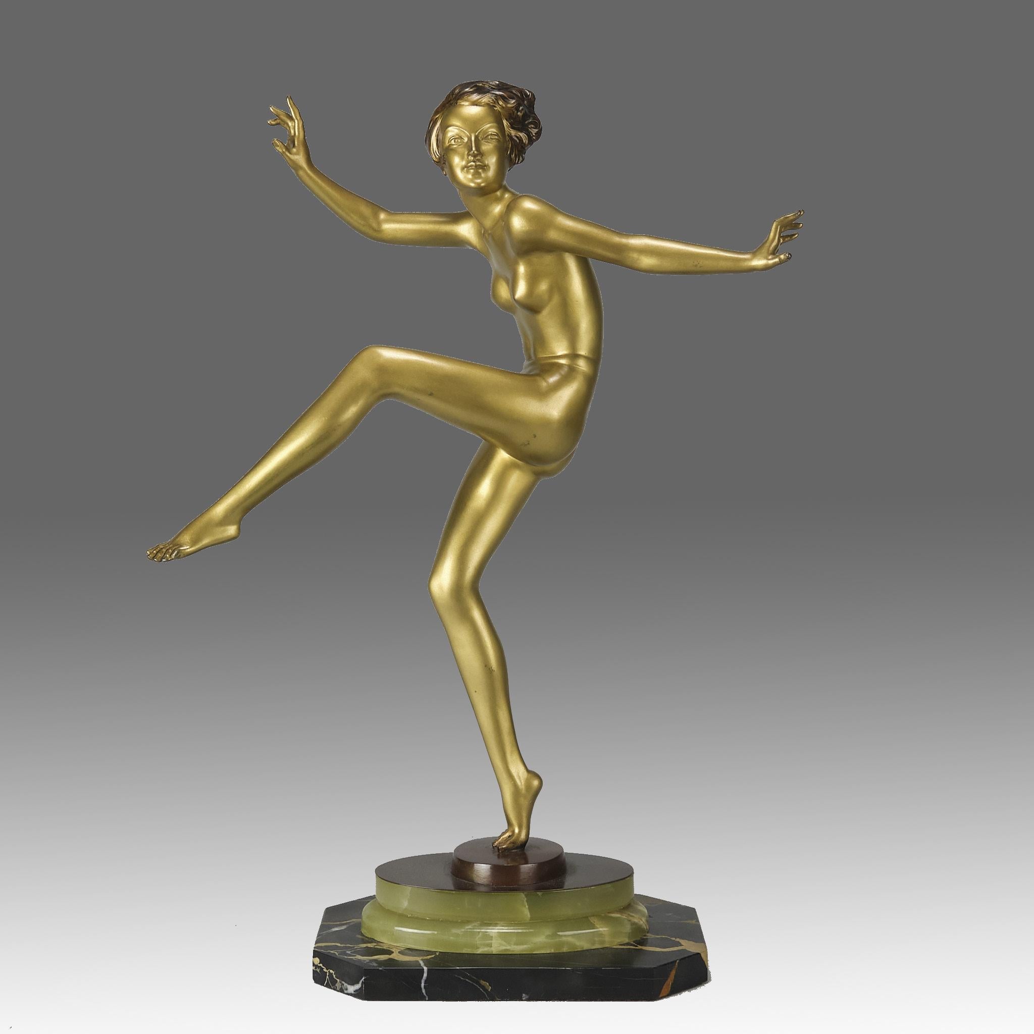 An impressive early 20th Century Art Deco cold painted gilt bronze figure of a young energetic beauty in a balanced dancing pose. The bronze exhibiting excellent colour and very fine hand chased surface detail, raised on a stepped onyx & marble base