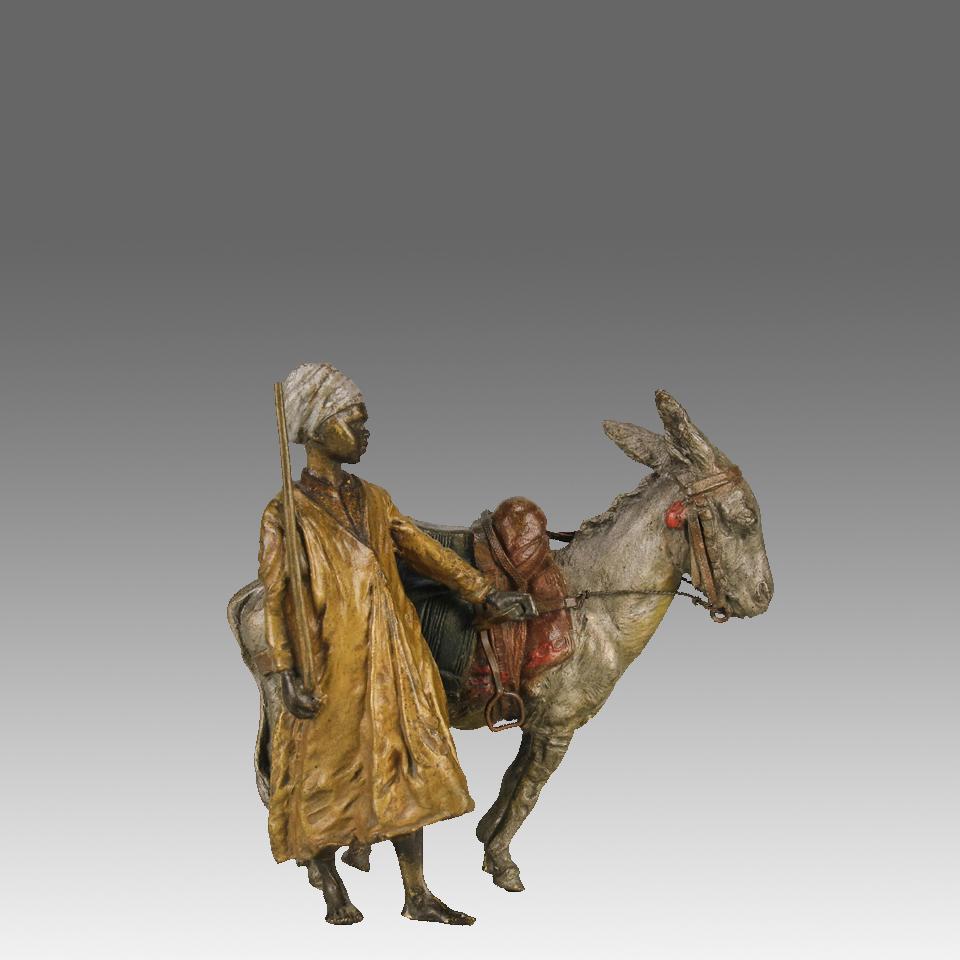 An excellent early 20th Century cold painted Austrian bronze study of a young Arab boy stood beside his saddled donkey. The bronze with excellent vibrant colour and exceptional hand finished surface detail, signed with the Bergman ‘B’ in an amphora