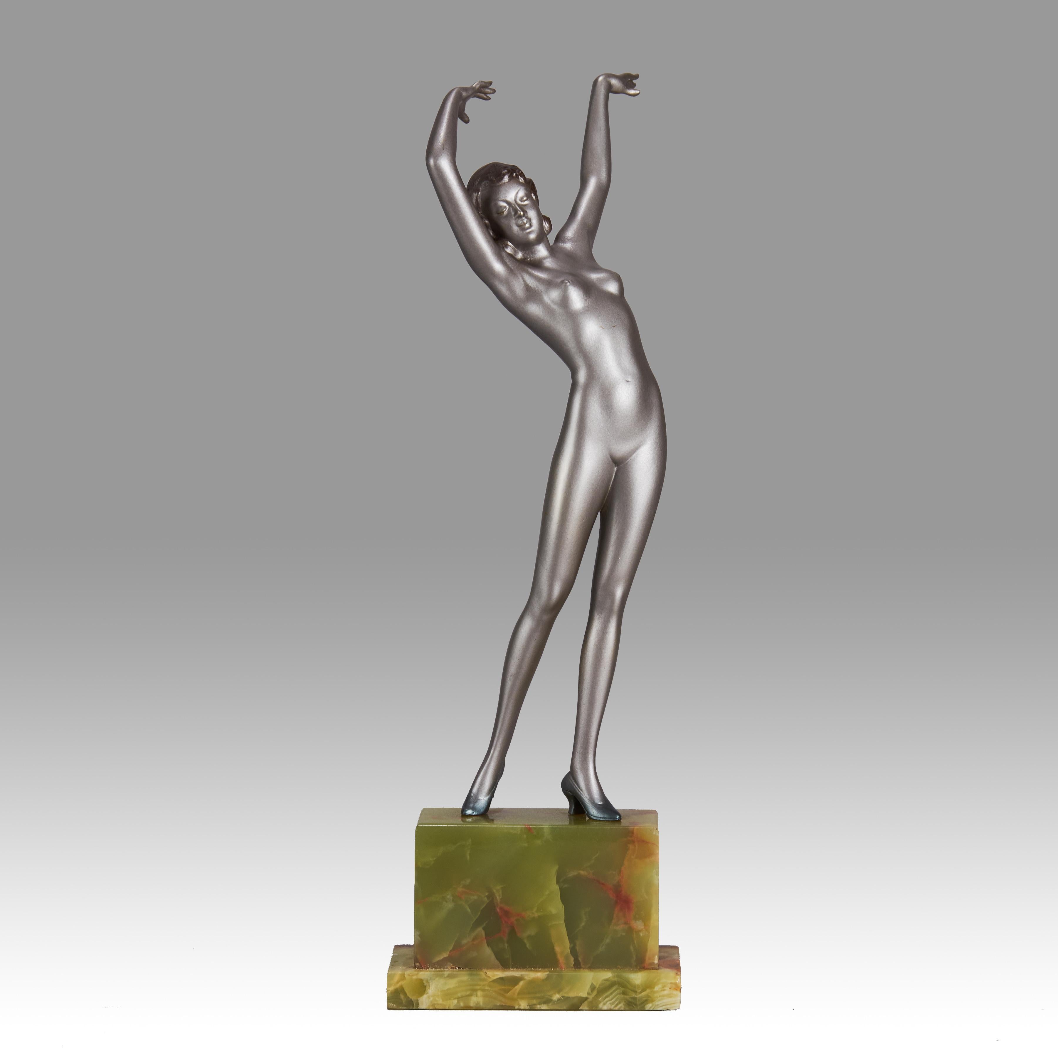 Striking early 20th Century Austrian Art Deco cold painted silver and enamel bronze figure of a young woman in stretched pose with her arms above her wearing only a pair of high heels . The surface of the bronze with excellent colour and very fine