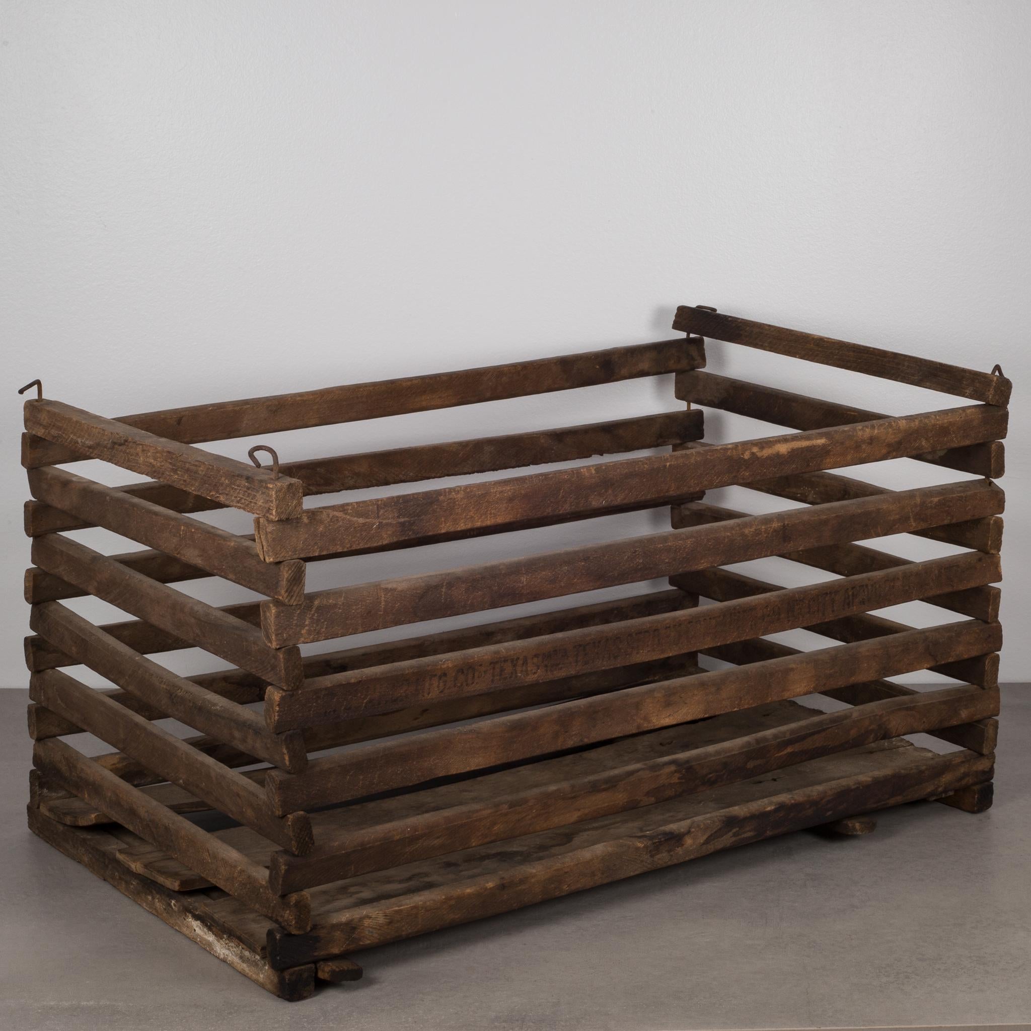 Slated wooden crate designed to collapse after use for better storage. Used to transport chickens and other poultry. The bottom panel pulls out and the main body collapses.