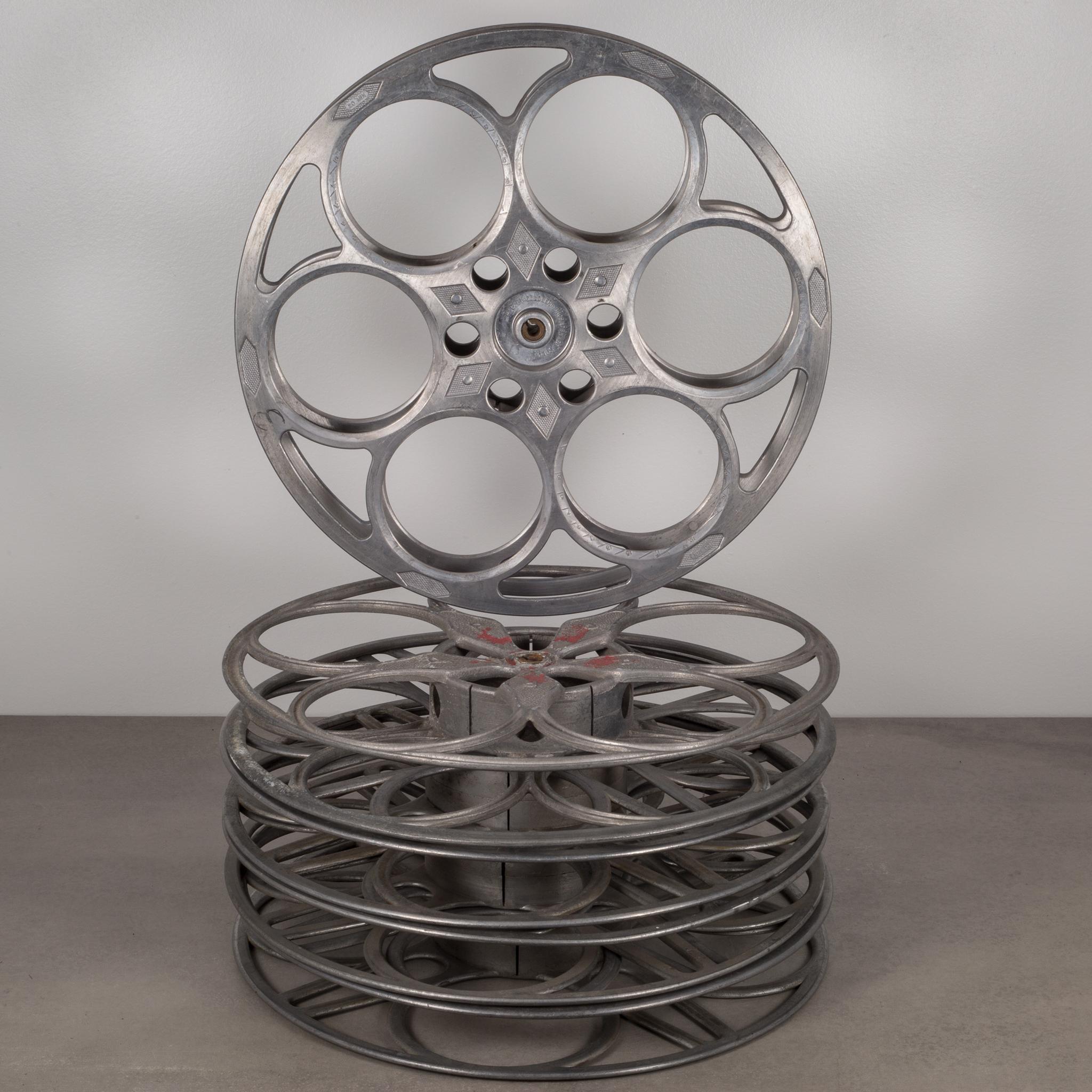 Collection of five antique metal film reels, circa 1930s. 
Keep them stacked in several piles on a shelf or on the floor or hang them up on a wall in row.