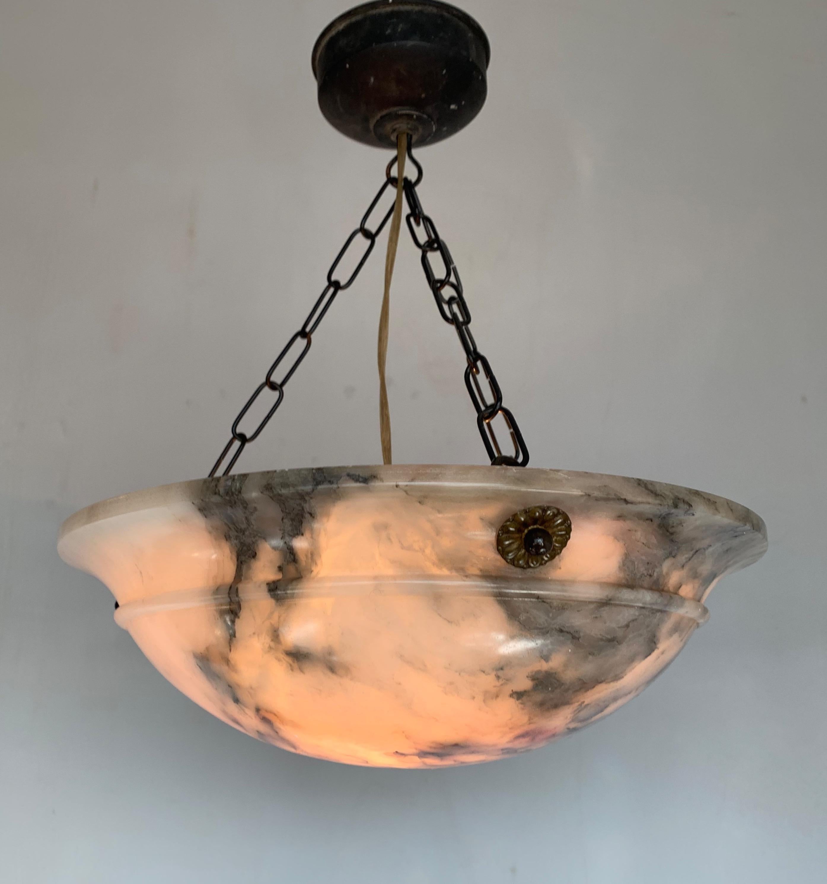 Lovely handcrafted and practical size alabaster dish / bowl pendant.

This Art Deco pendant has a beautiful and timeless shape, but what makes this particular pendant really rare is its many 'faces'. This alabaster light has a different look from