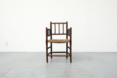 Early 20th Century Cottage Style Hand-Carved Wooden Bobbin Chair w/ Rattan Seat