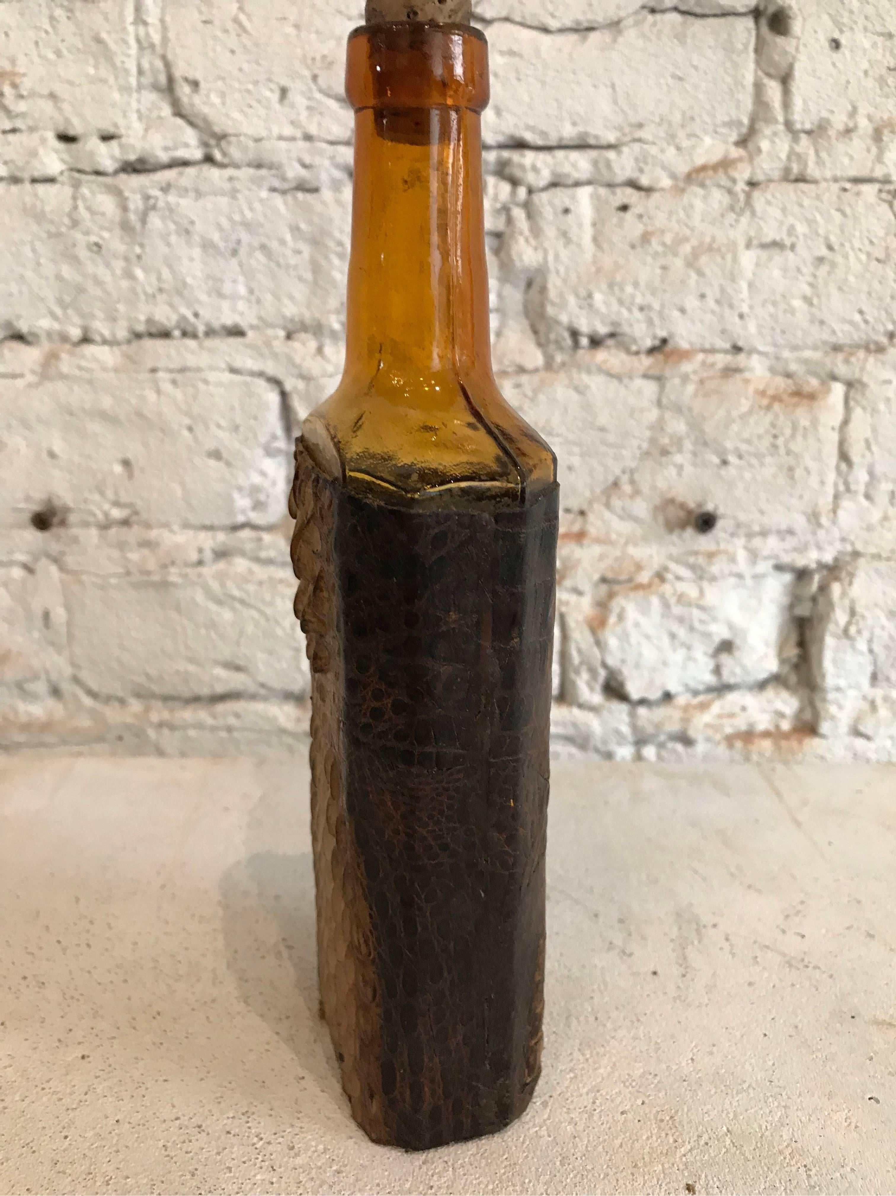 Early 20th century German amber glass and crocodile bottle.