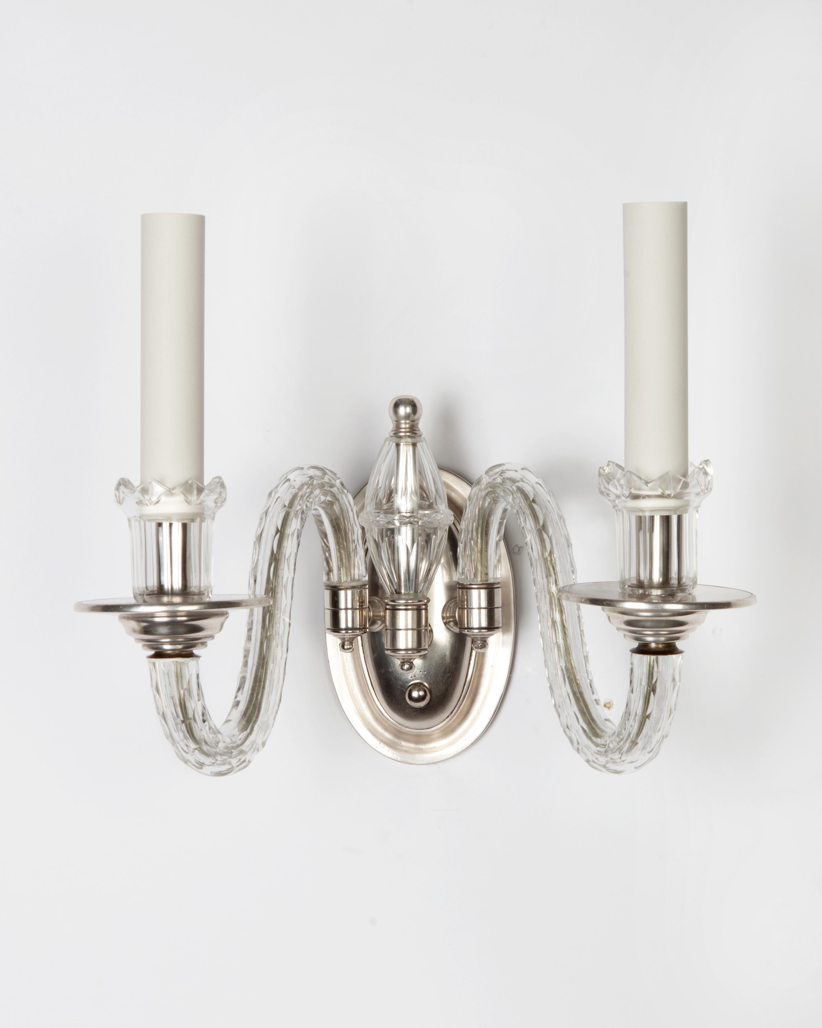 AIS2897,

circa 1920
A single double-light sconce with cut-glass arms, cups, and central spire in its original aged silver plate finish. Due to the antique nature of this fixture, there may be some nicks or imperfections in the