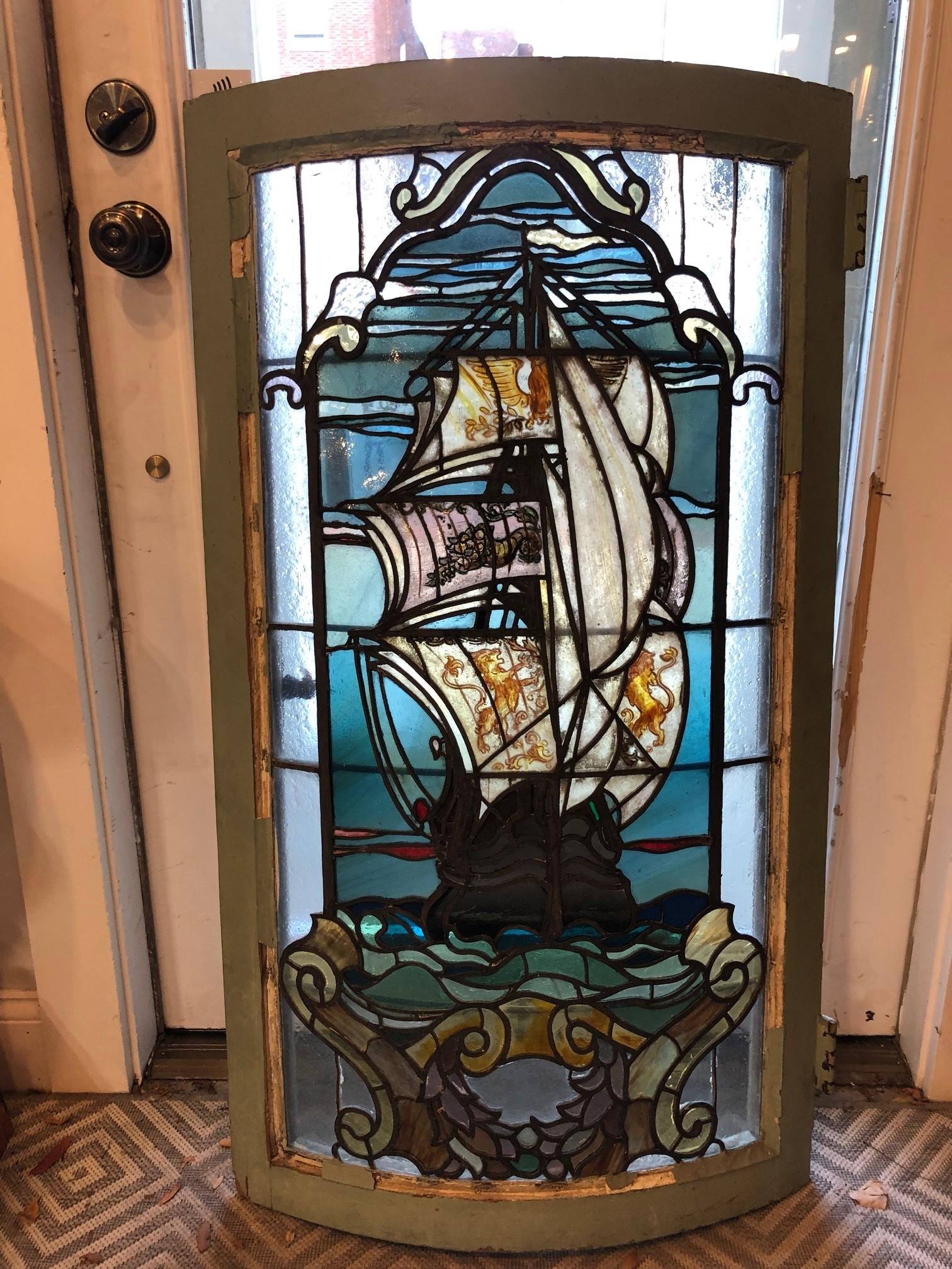 Early 20th century curved stainglass window from an Upstate NY Estate. This stained glass came out of a curved window in a library of a private home. The glass is in good condition no breaks or cracks only the frame needs work but is solid and