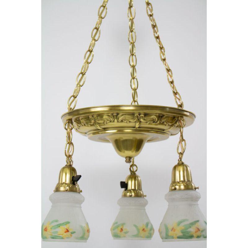 Multitier daffodil pan light. Chain can be shortened during installation. Reverse painted daffodil shades to add a touch of spring.

Material: Glass,Brass
Style: Traditional
Place of Origin: United States
Period Made: Early 20th