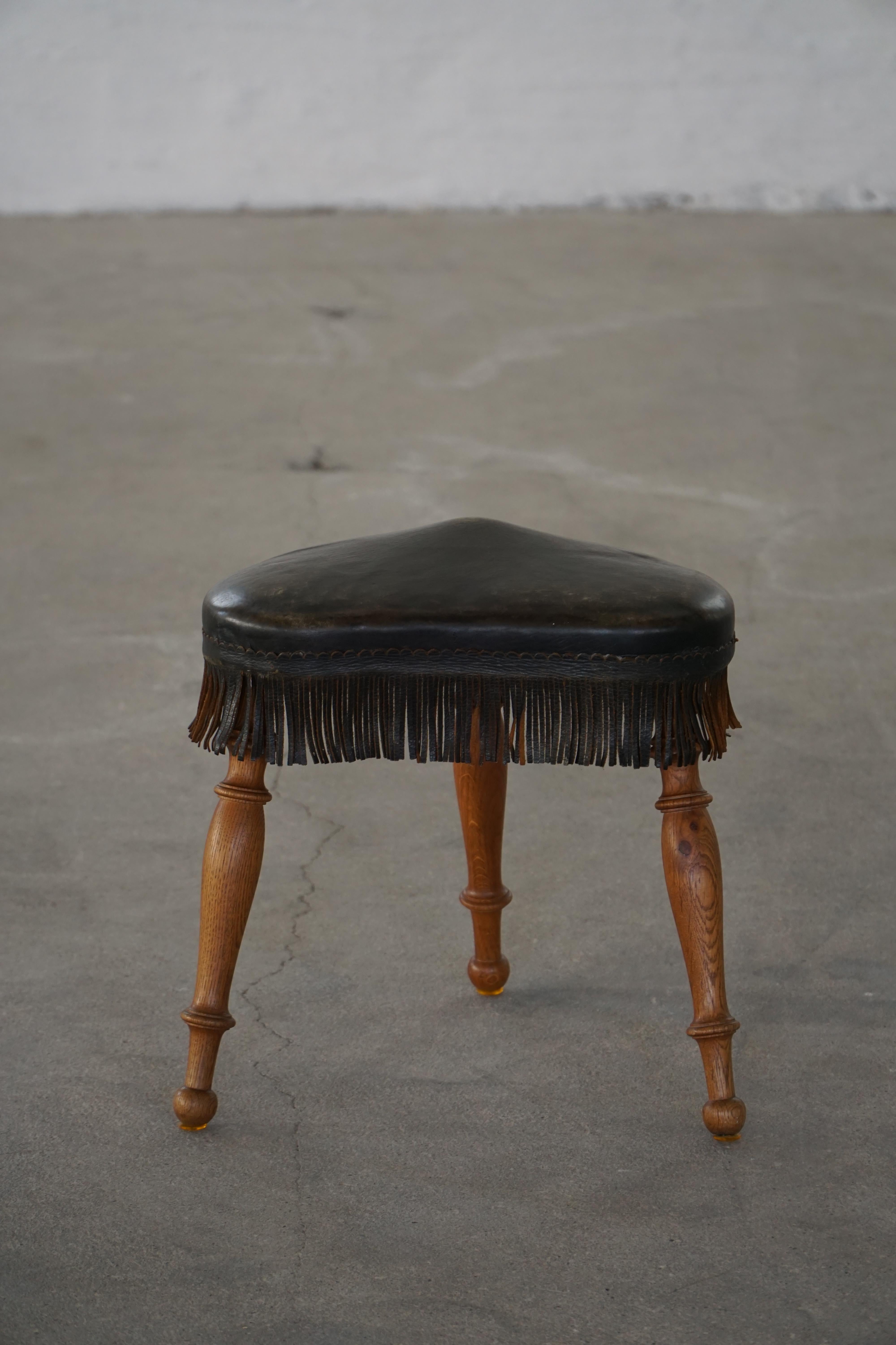 Hand-Crafted Early 20th Century, Danish Tripod Oak Stool with Leather Fringe, 1930s For Sale