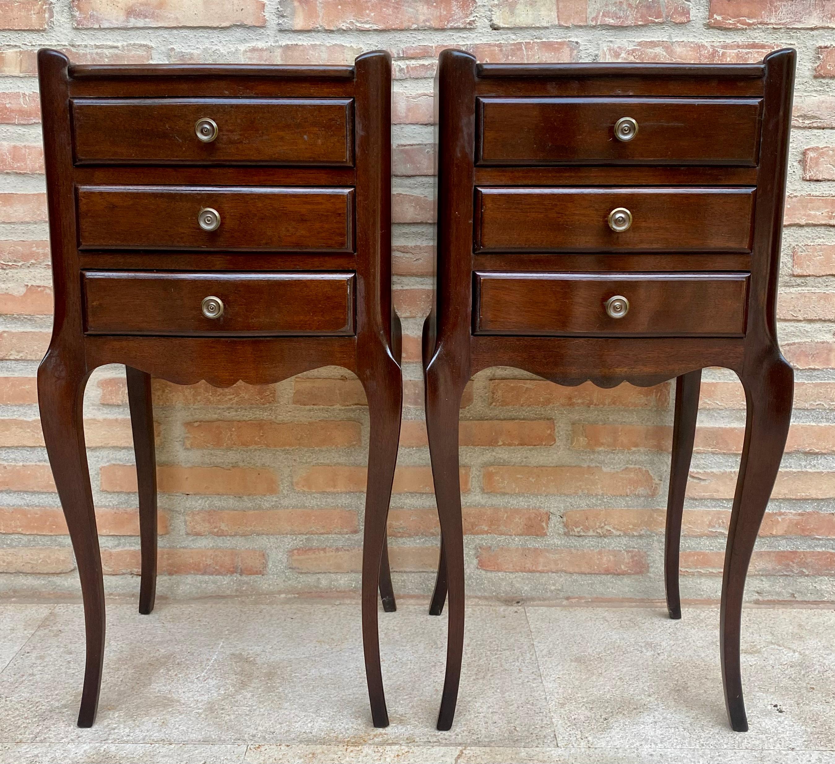 Lovely small dressers/nightstands with small drawers and metal knobs. A raised edge that surrounds the top on 3 sides. The table rests on 4 cabriole legs. The skirt is scalloped on the front and side panels. Three small elegant drawers to store as a