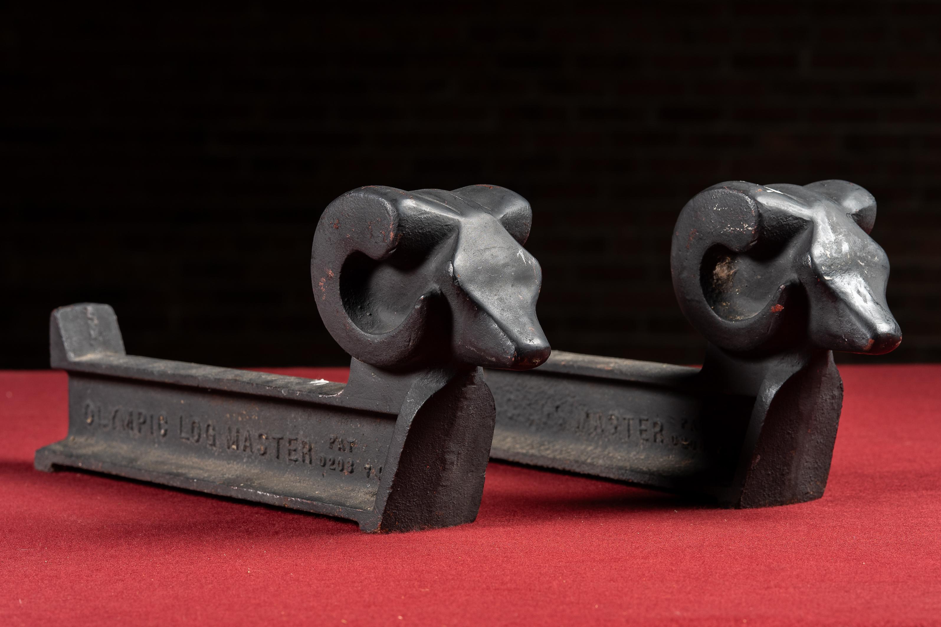 c. 1900s-1910s; Olympic Logmaster - Chicago, IL

Pair of cast iron andirons with stylized ram's head finials, marked 