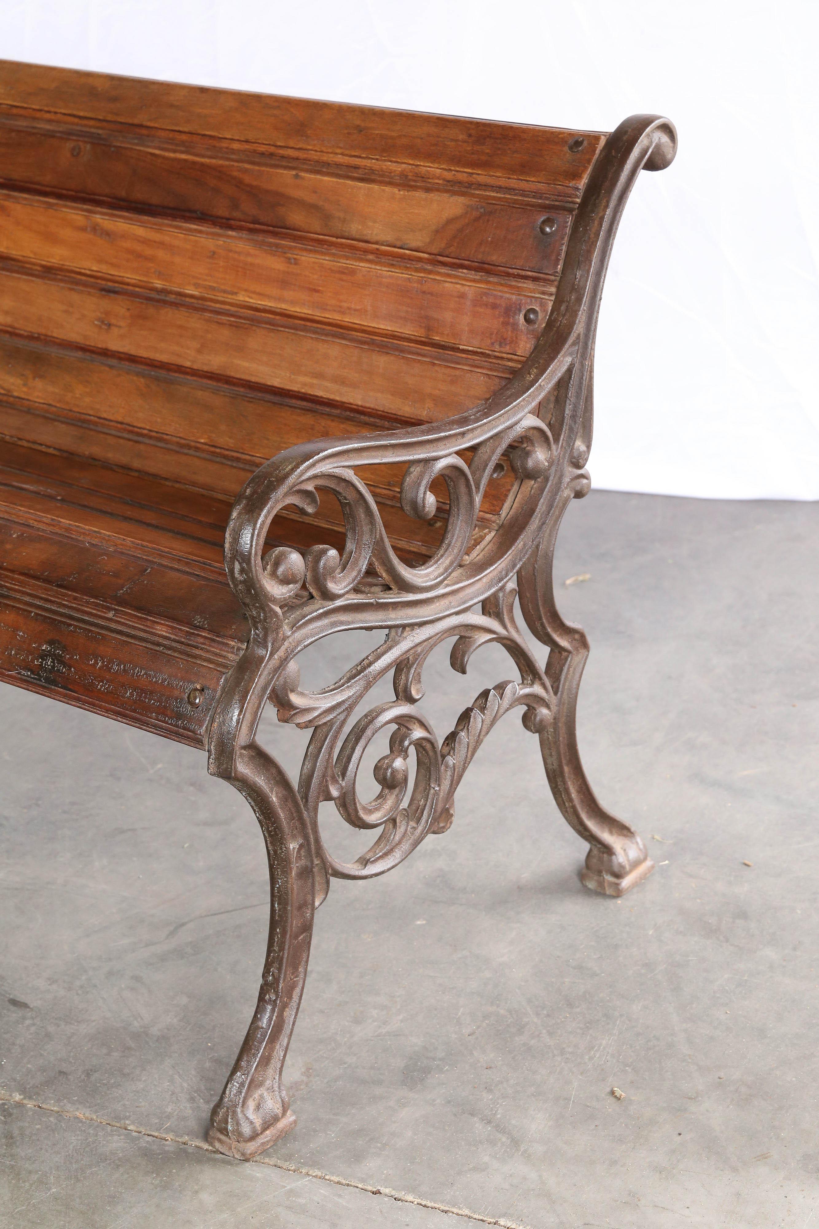 Benches like this one were extensively used in colonial time in rail road stations, parks and gardens. The supports were hand cast in iron and the seats are made of teak wood and are easily replaceable. Because the seat and back are curved one can