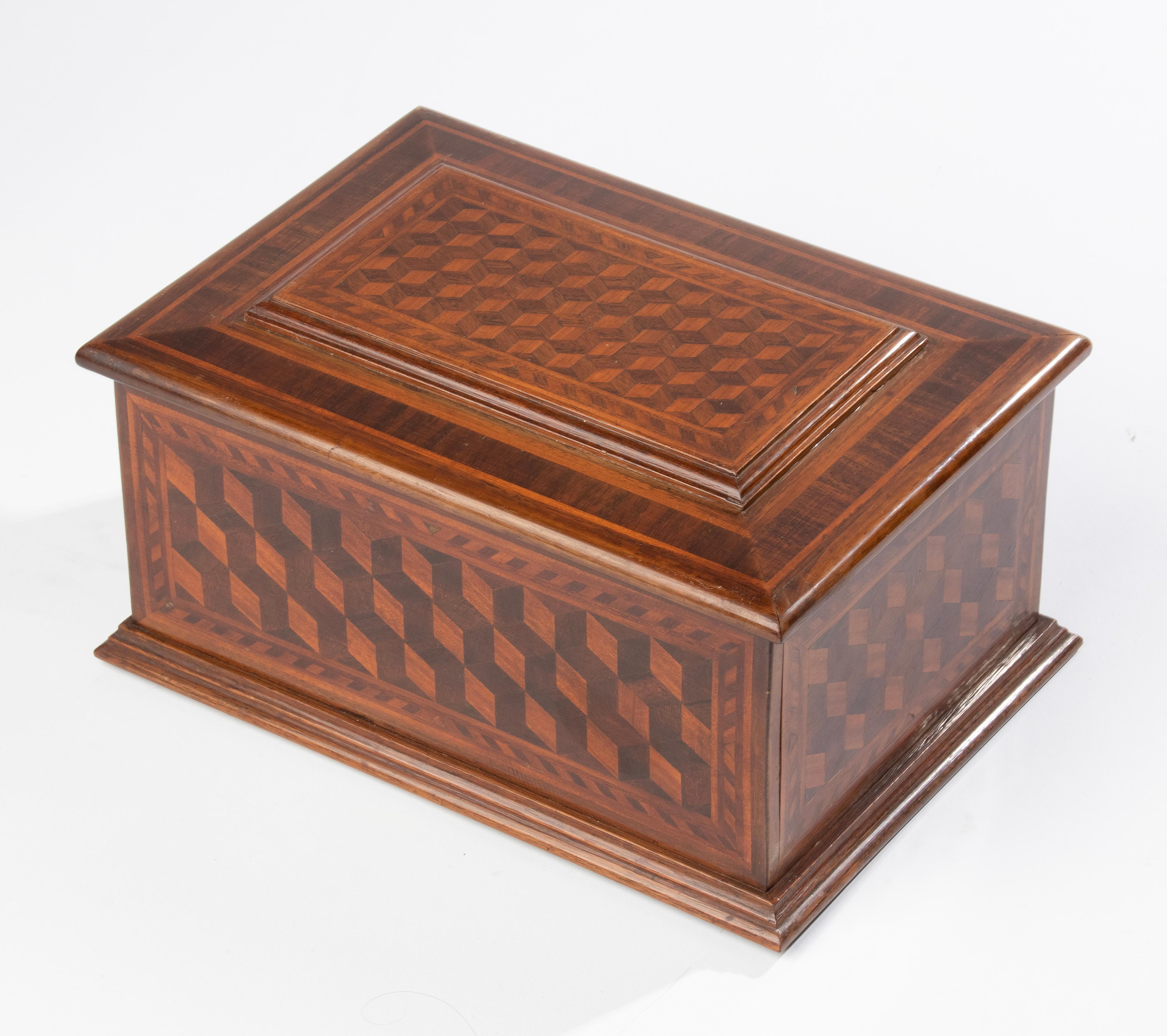 Decorative wooden box. Beautiful traditional marquetry wood work, the box is inlaid with different types of wood in a cubist pattern. The box dates from circa 1910-1920, originating from France.