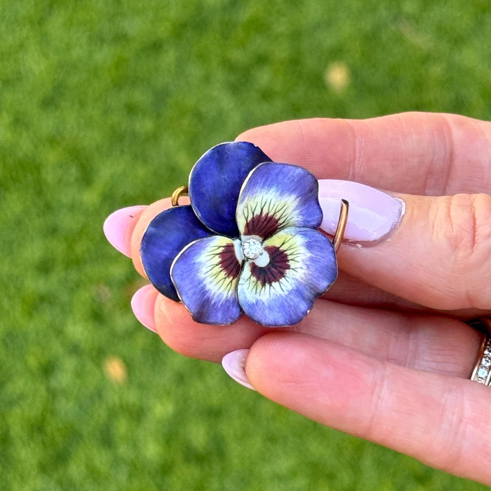 Vintage 18k yellow gold diamond and violet enamel pansy pin with retractable bail. This beautifully crafted piece features richly colored violet enamel petals with fine detailing and a sparkling old European cut diamond at the center, approximately
