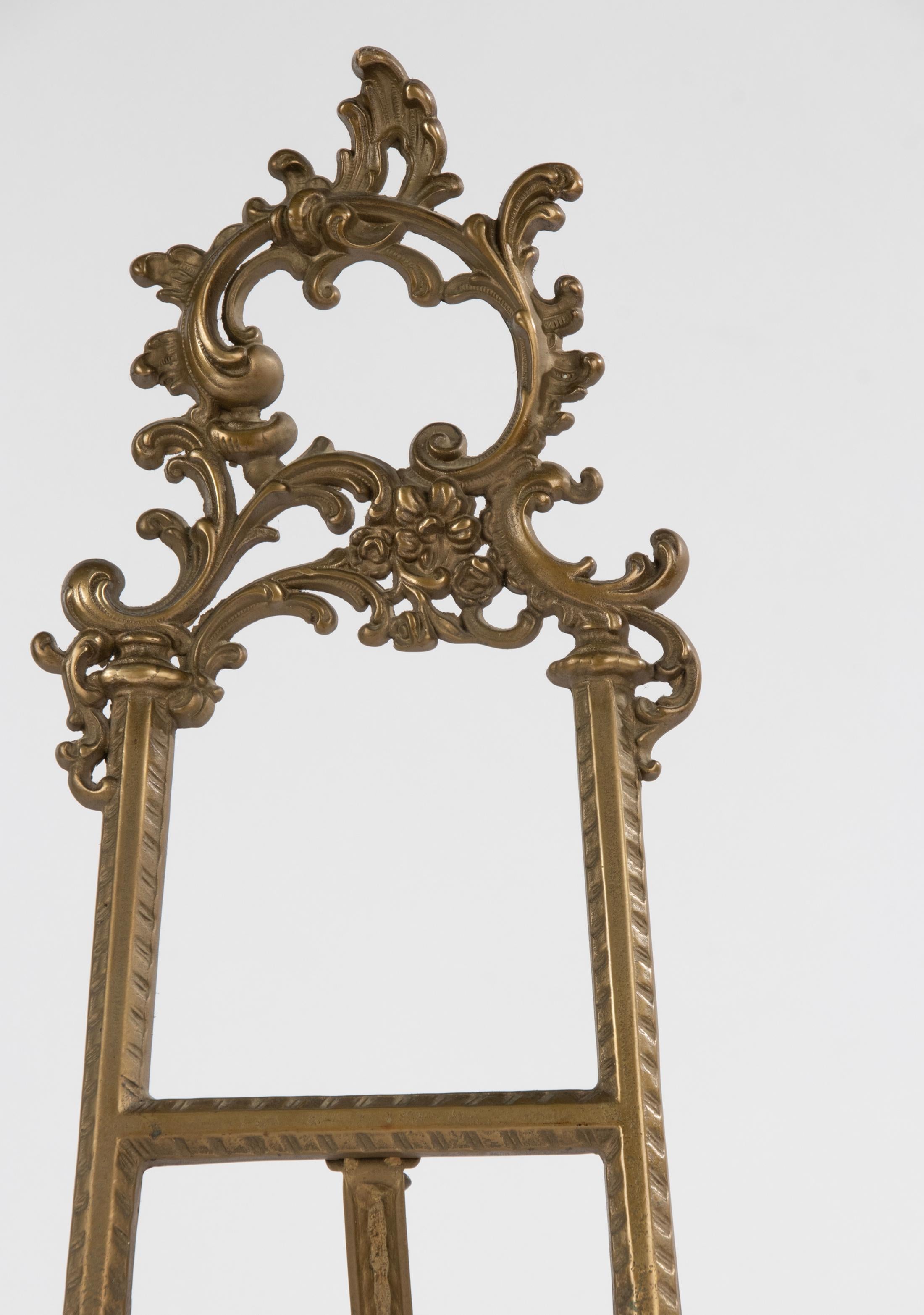 A beautiful early 20th century brass display stand, decorated in rococo style. 
The stand is made of brass. 
Beautiful colour and patina. 
A nice piece for displaying paintings, drawings or books. 
The stand is in very good condition. Sturdy and