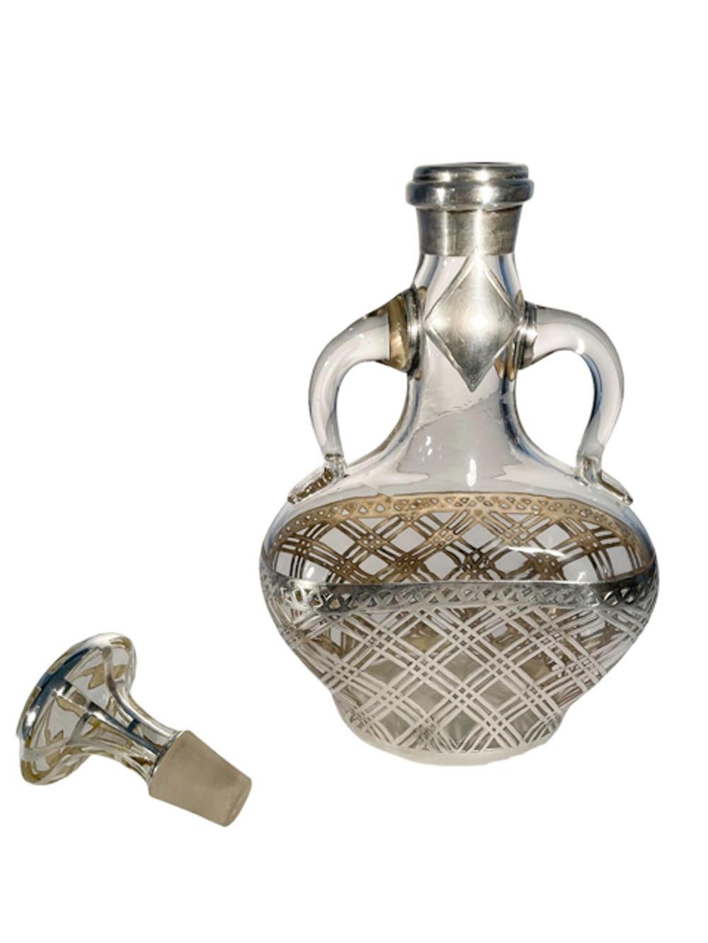 Early 20th century blown glass decanter / back bar bottle with double handles and silver overlay in an openwork basket weave pattern.