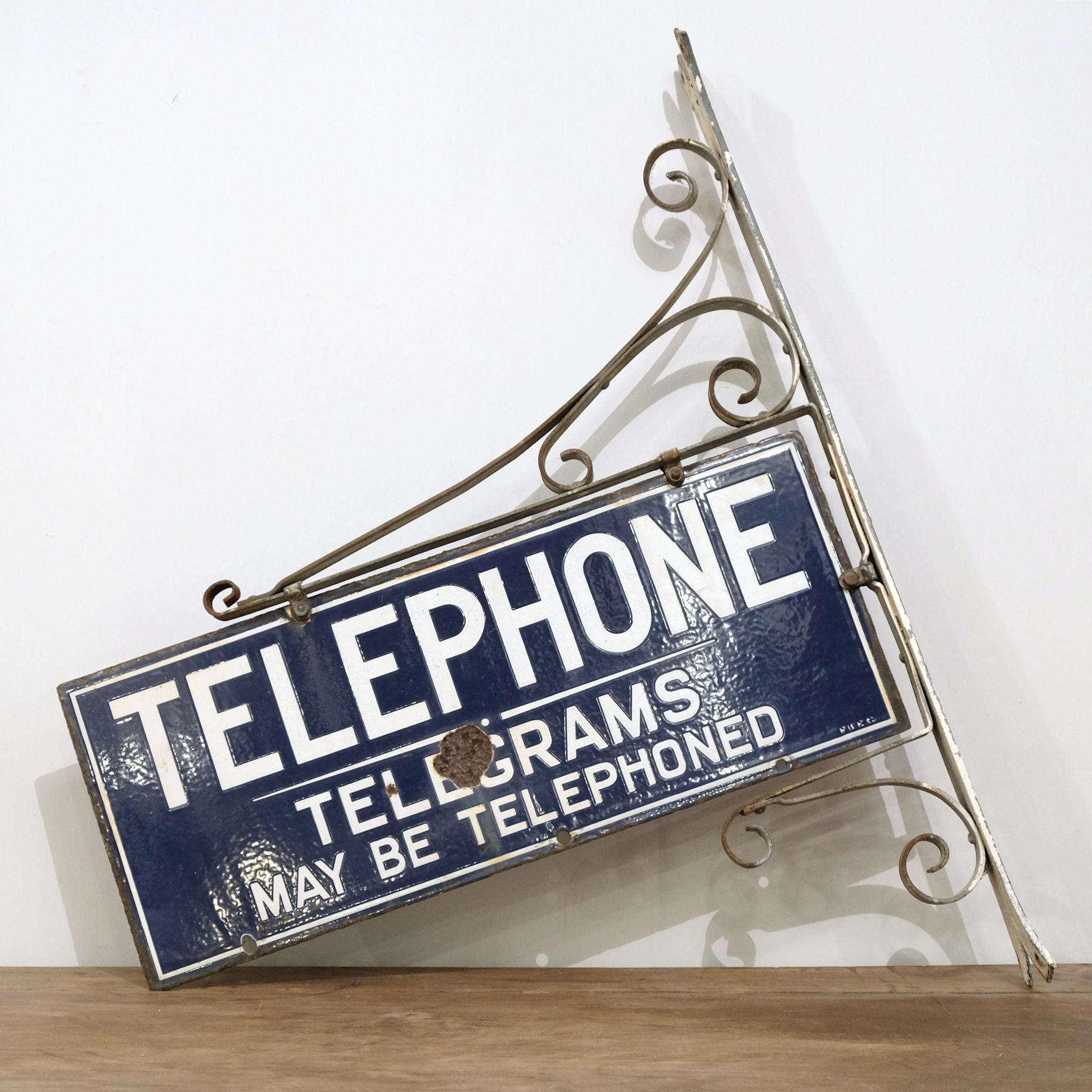 Original circa 1930s double-sided enamel sign which would have been displayed outside a post office or telephone box. This is a slightly more unusual example as it also informs that telegrams can be sent using the telephone. On original wrought