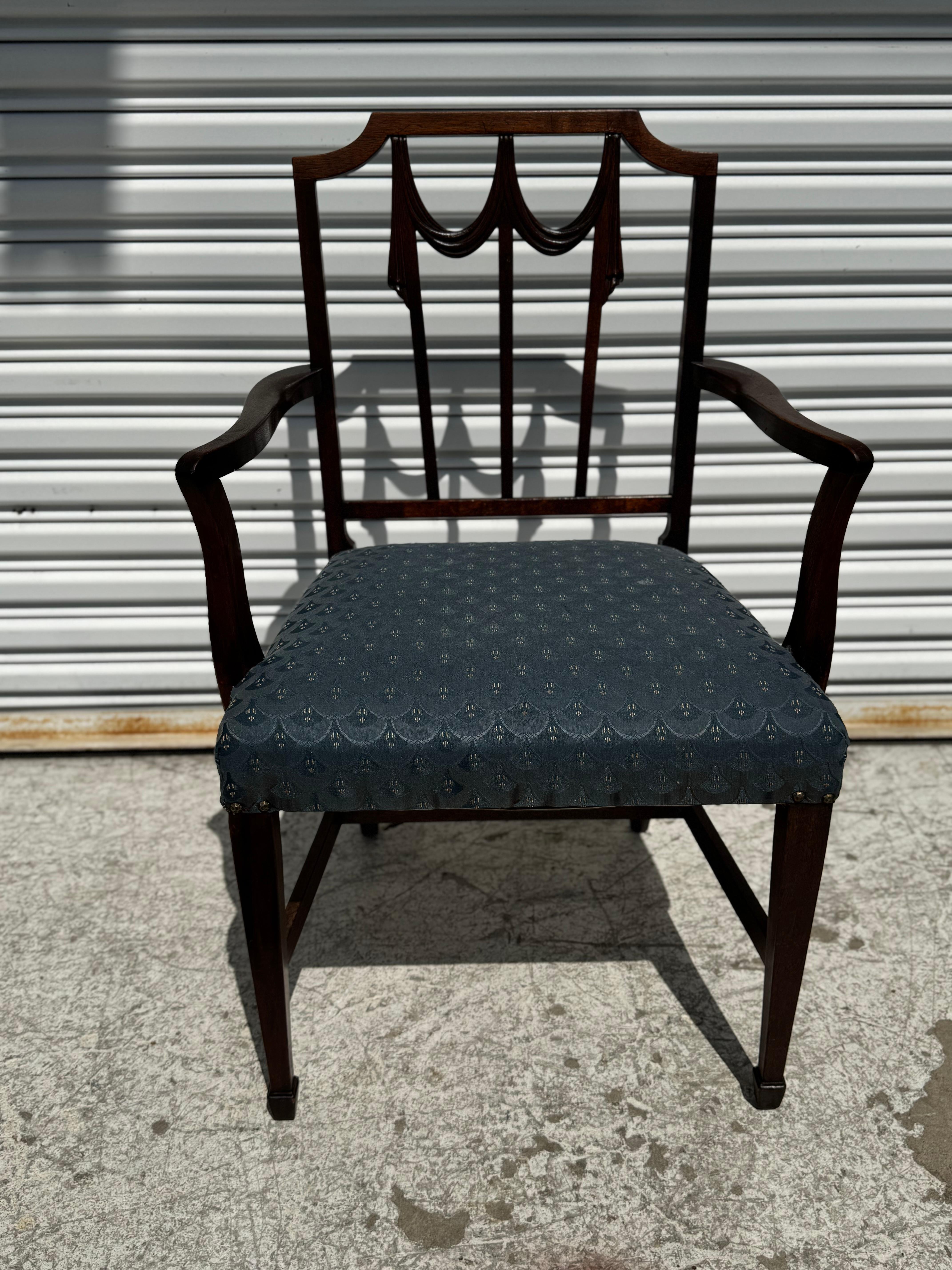 This is a Duncan Phyfe armchair in the Lincoln Drape style. 
The chair is American and made of mahogany.
The chair is nicely upholstered.

Arm height is 25