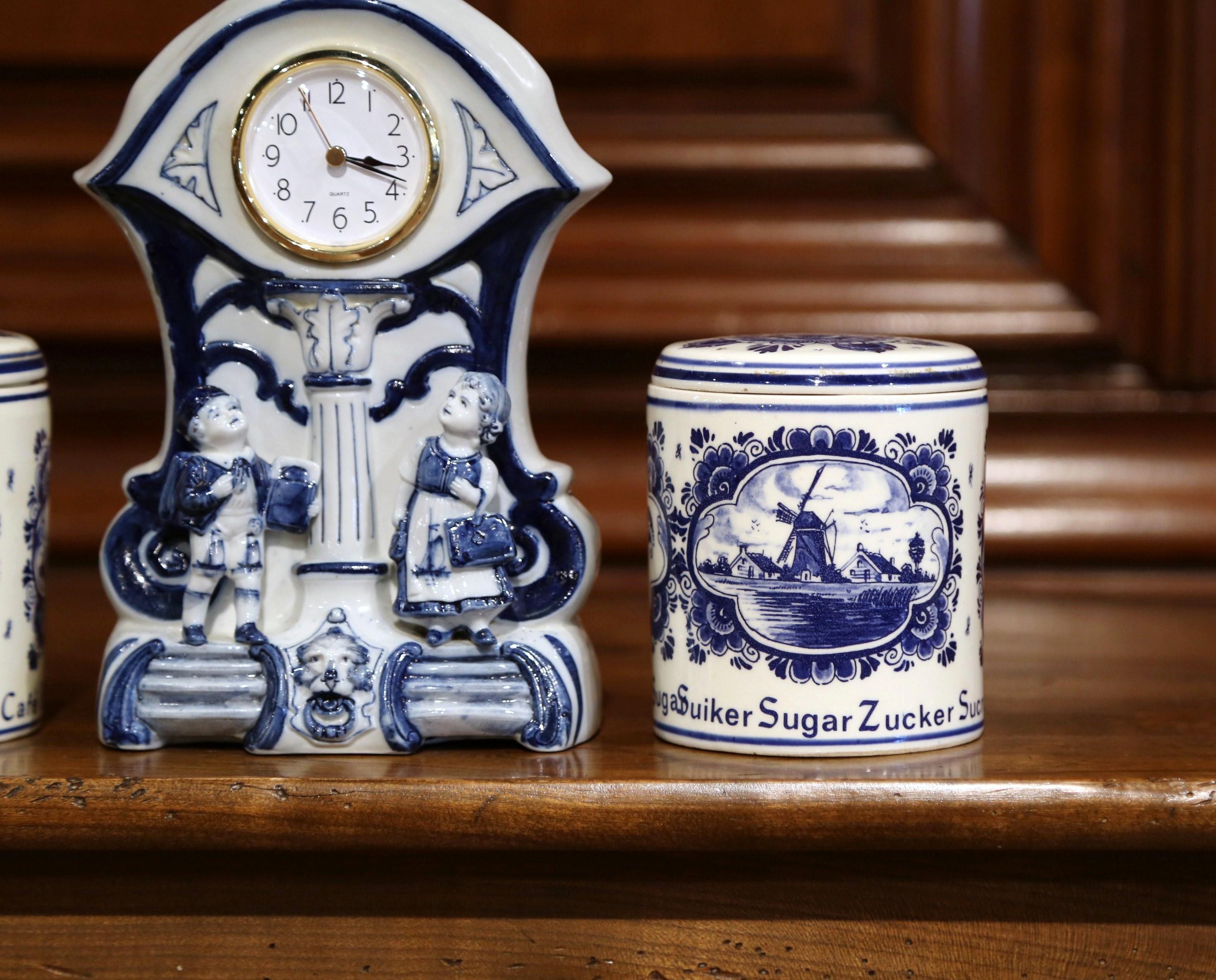 Hand-Crafted Early 20th Century Dutch and German Three-Piece Delft Canisters and Clock