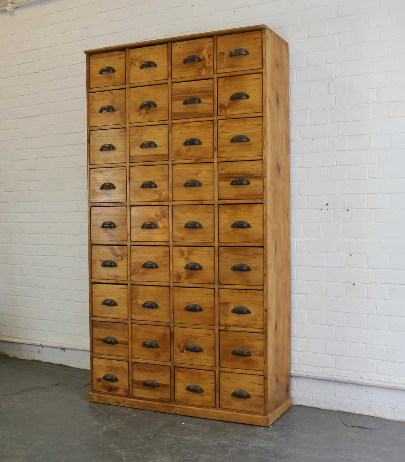 Early 20th century Dutch hardware store drawers

- Ornate cast iron handles
- Solid pine drawers and cabinet
- 36 identical drawers
- Originally used in a hardware store to house nut and bolts
- Dutch, 1910
- Measures: 110cm wide x 41cm deep