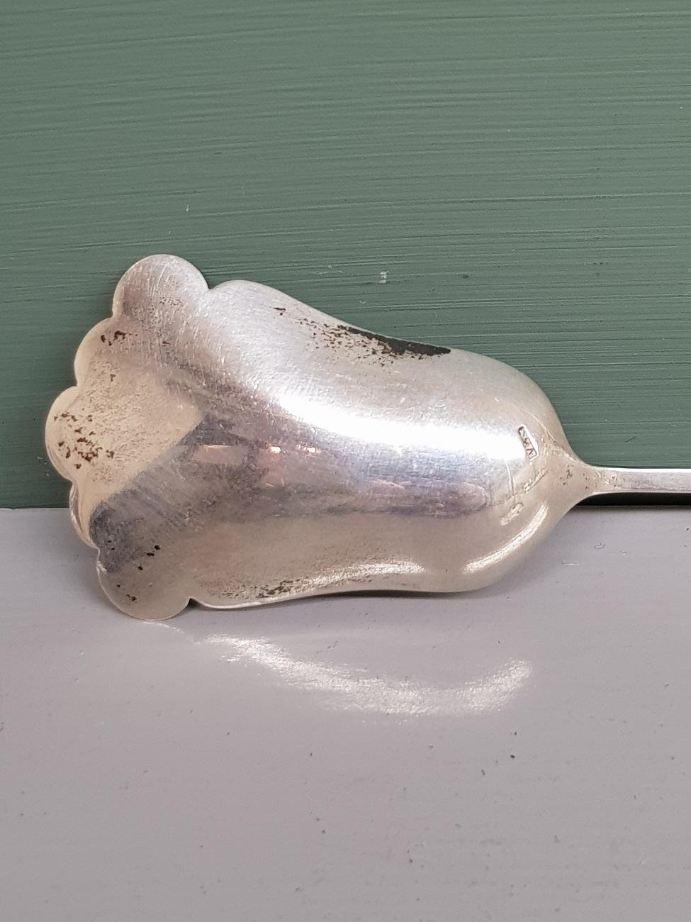 Old Dutch silver sugar spoon with a cut agate as a handle and it is marked with a sword and unknown maker's mark, early 20th century.

The measurements are,
Depth 1.5 cm/ 0.5 inch.
Width 3.3 cm/ 1.2 inch.
Height 12.2 cm/ 4.8 inch.