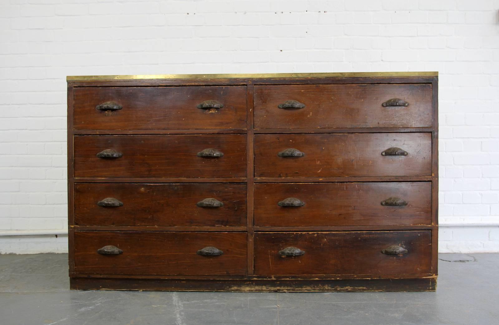 - Price is per unit (two available)
- Each unit consists of eight large drawers
- Solid pine
- Beautiful ornate cast iron handles with belt buckle detail
- Brass edging
- Salvaged from a tailors in central Amsterdam
- Dutch, circa 1900
- Each