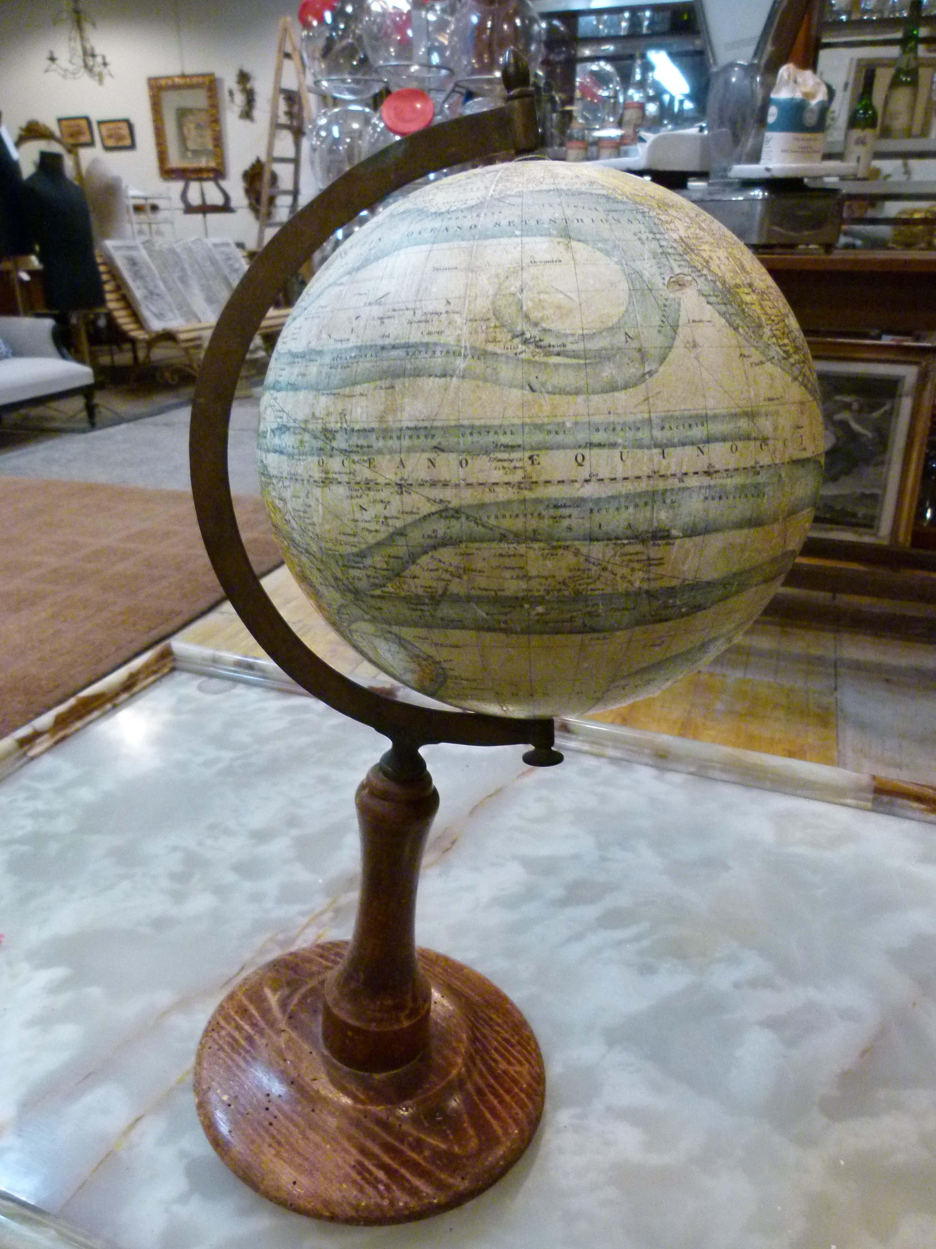 Early 20th century earth globe.
Wooden base and Globus made of plaster and paper.
As you can see in one photo the paper has been damaged in this one place. The rest is in perfect conditions.