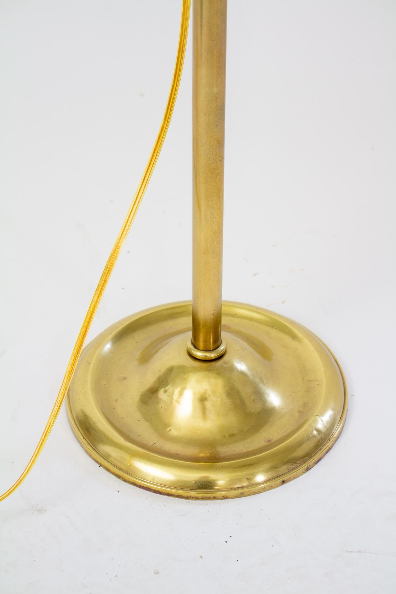 Early 20th Century Edward Miller & Co. adjustable bridge lamp. Brass with brass colored shade. The height and angle of the lamp are adjustable. Base is marked EM & Co. Early 20th Century, US. Rewired with replacement socket, shade is replacement