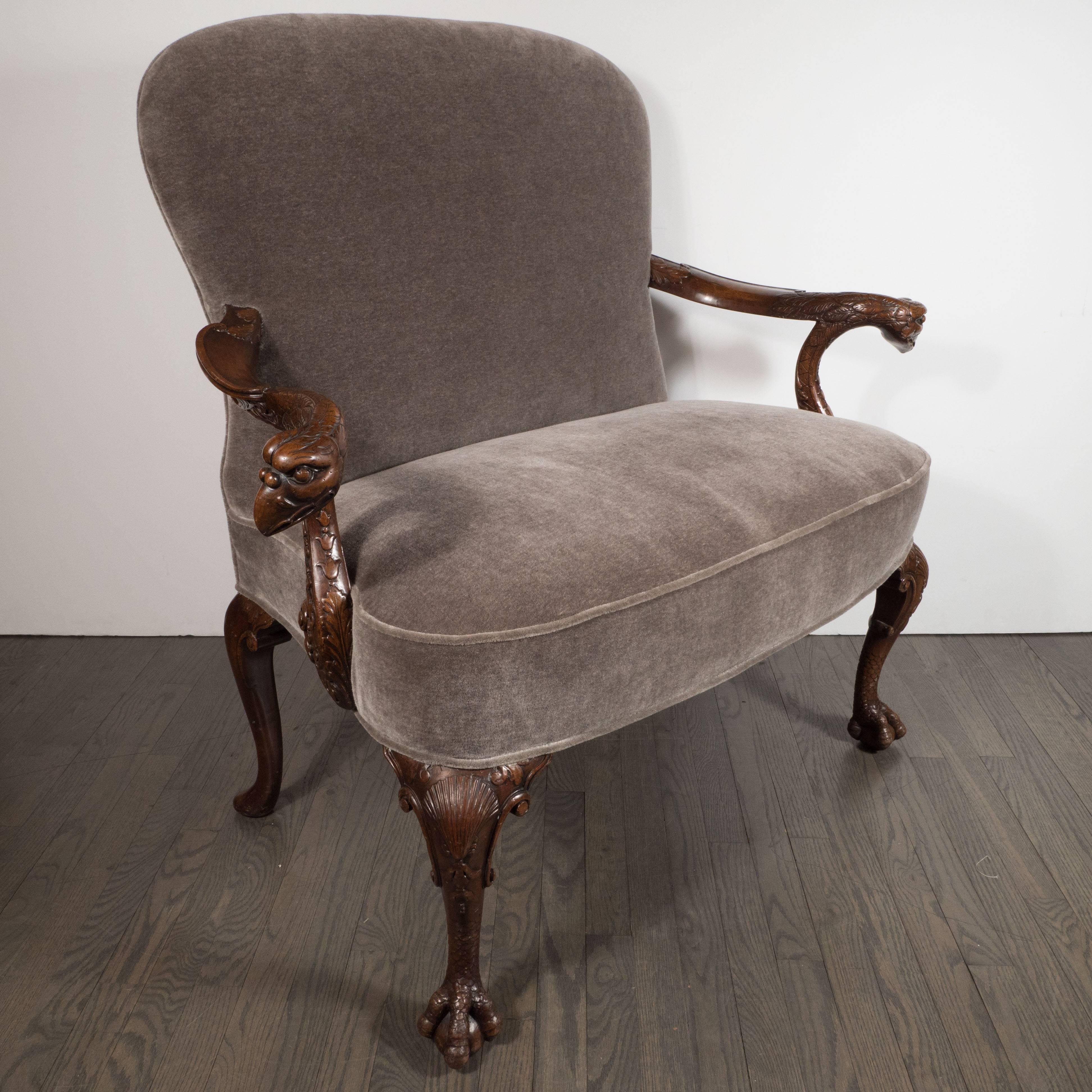 This stunning Edwardian occasional chair was realized in England at the beginning of the 20th century. It is a first-rate example of design from the time and place. It features neoclassical motifs carved throughout, including an aves motif depicting