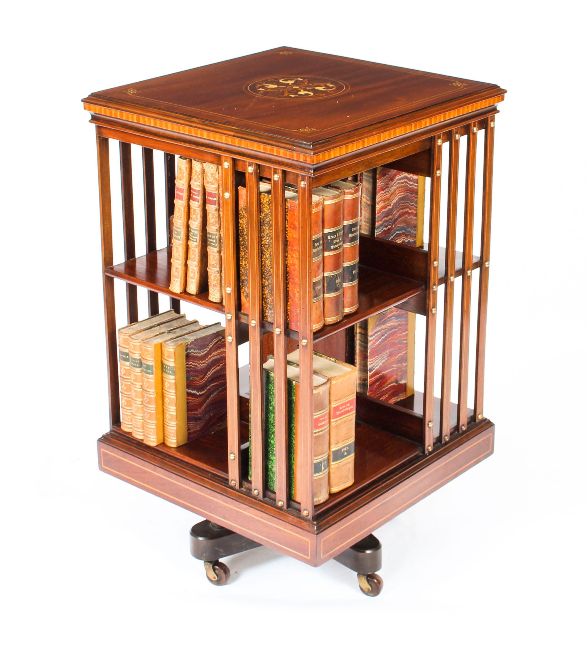 This is an exquisite antique Edwardian marquetry inlaid mahogany square revolving bookcase, circa 1900 in date.

This exquisite revolving bookcase is made of beautiful solid mahogany and the top has been masterfully inlaid with elaborate mythical