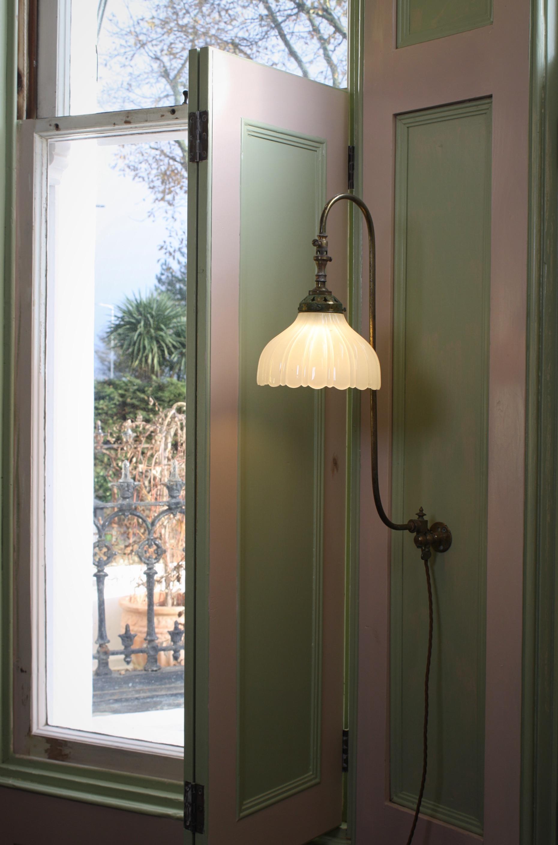 A pretty swan neck Jefferson wall sconce, the brass stems previously used for gas have been converted to electric.

All metals sections have areas of patina and age related oxidisation, the thick pressed milk glass shades is in perfect