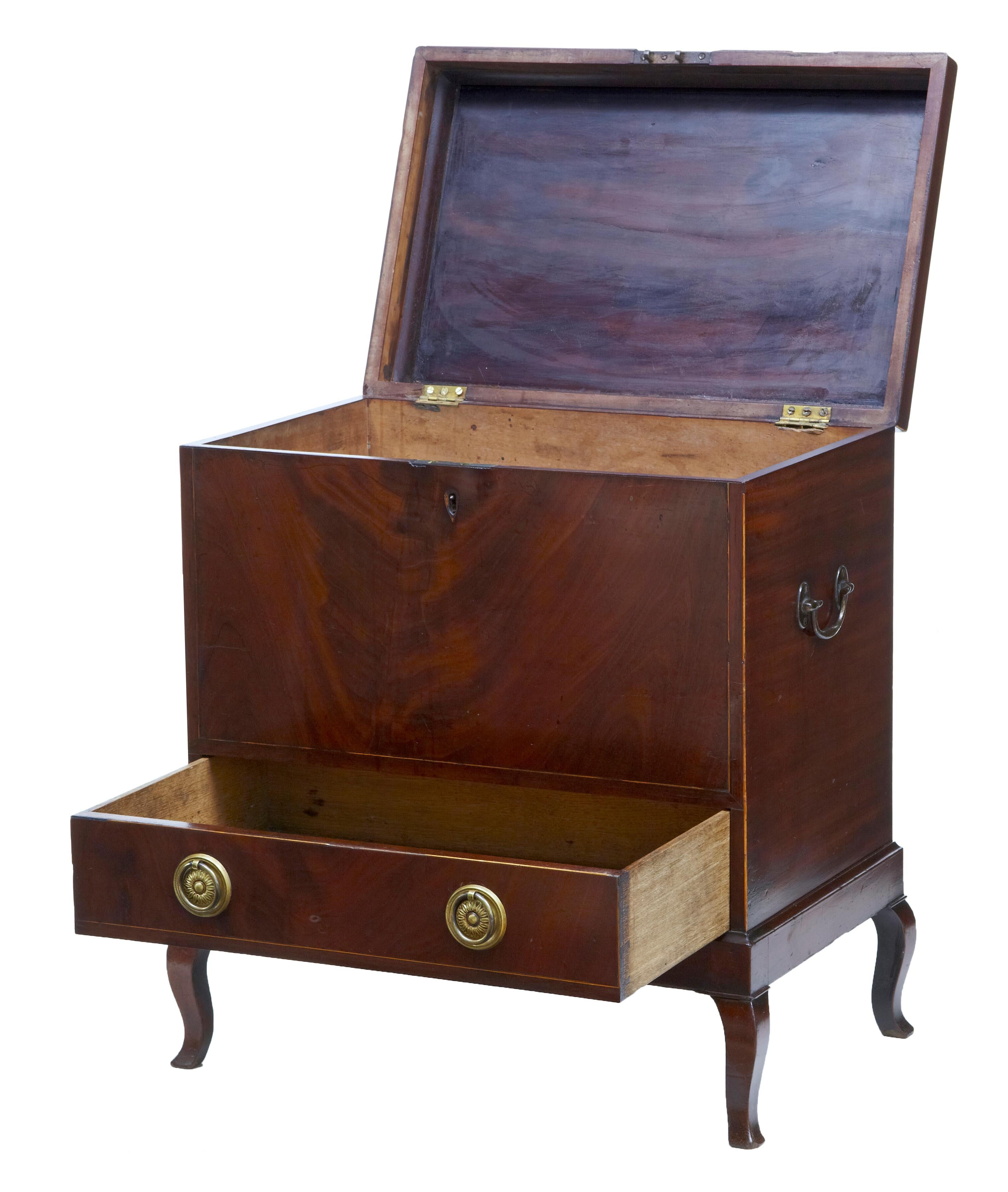Early 20th century Edwardian mahogany inlaid wine cooler, circa 1905.

Sheraton revival wine cooler cellarette. Top with oval stringing and inlaid ebony. Lid opens to reveal compartments for bottle storage, drawer below. Standing on 4 cabriole
