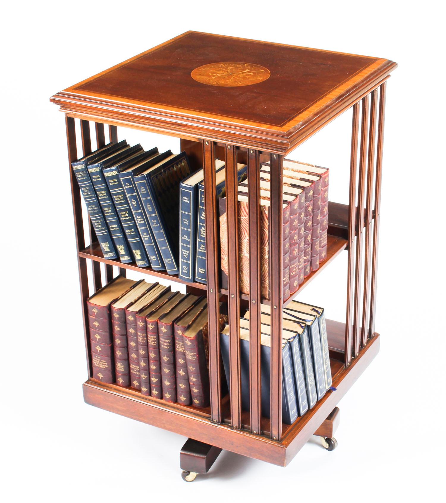 This is an elegant Edwardian antique revolving bookcase made by the renowned retailer and manufacturer Edward & Roberts for Spetchley Park House circa 1900 in date.

It is made of chestnut colored mahogany with banding in satinwood and strung with