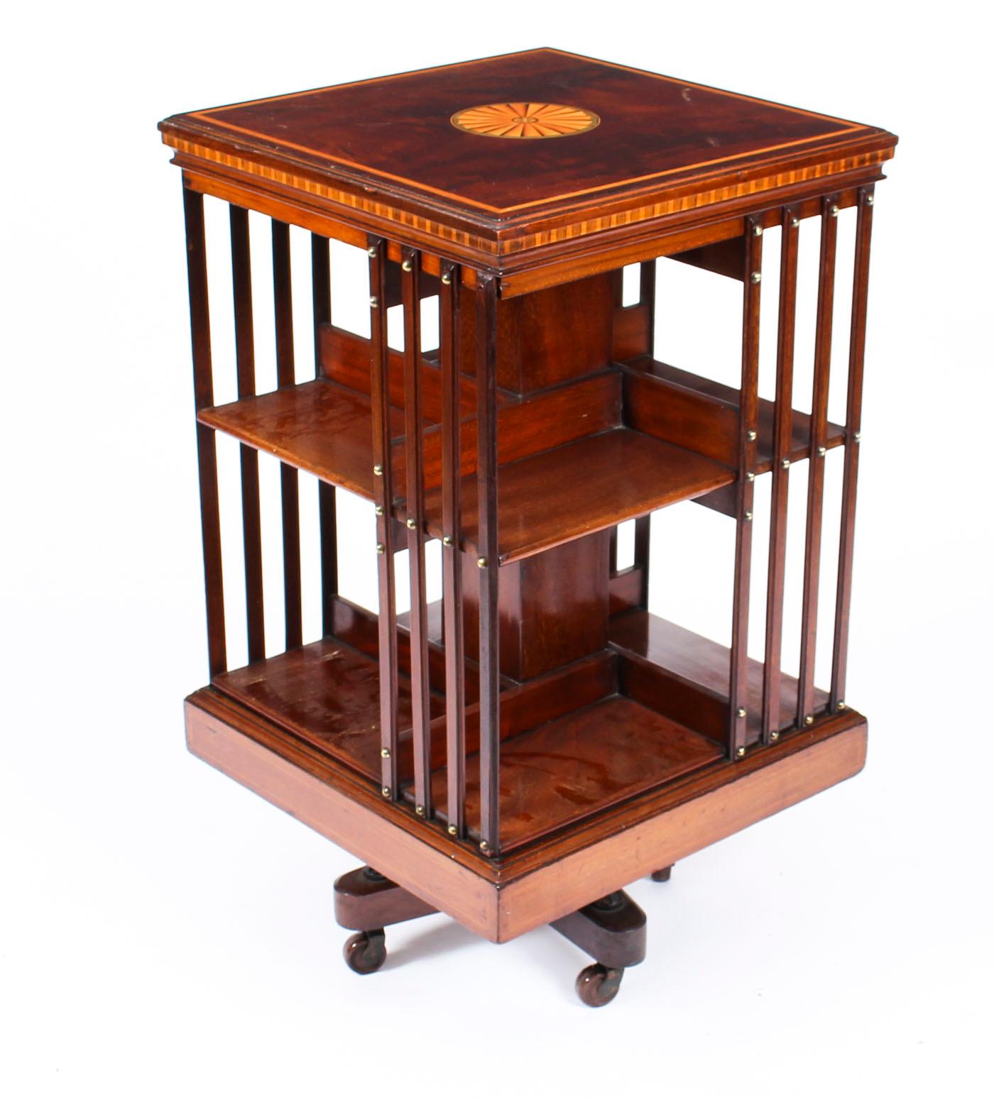 This an exquisite antique revolving bookcase attributed to the renowned Victorian retailer and manufacturer Maple & Co., circa 1900.

It is made of mahogany , revolves on a solid cast iron base, has inlaid boxwood lines to the top and bottom, the