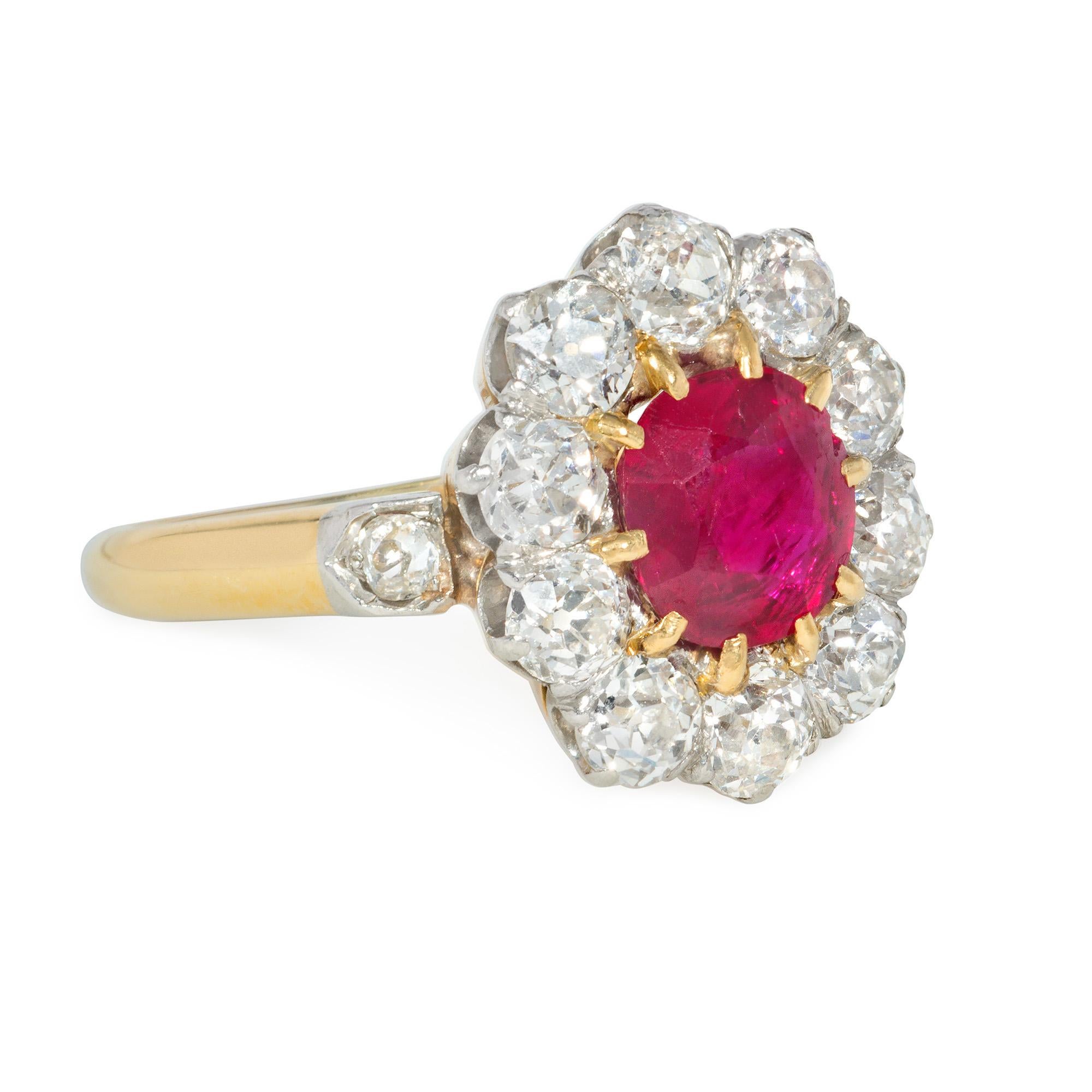 An early 20th century Edwardian period ruby and diamond cluster ring with diamond-set shoulders, in platinum and 18k gold. French import.  Atw ruby 1.40 cts., atw diamonds 1.75 cts.  AGL report stating no heat treatment, origin: Thailand

Face-up