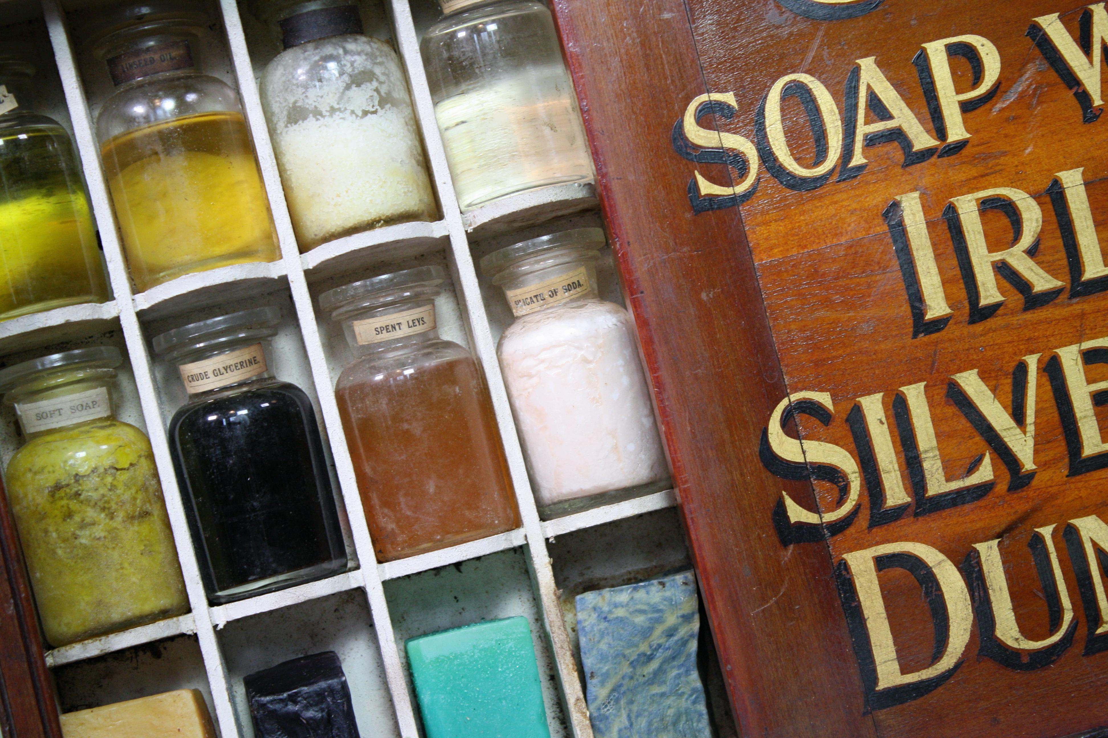 A unusual travelling tradesman's soap display case, early 20th century in age likely Edwardian.

A segmented internal draw hidden via the sliding cover, housing fourteen hand blown glass vials and six blocks of sample soap. Inside the vials are a