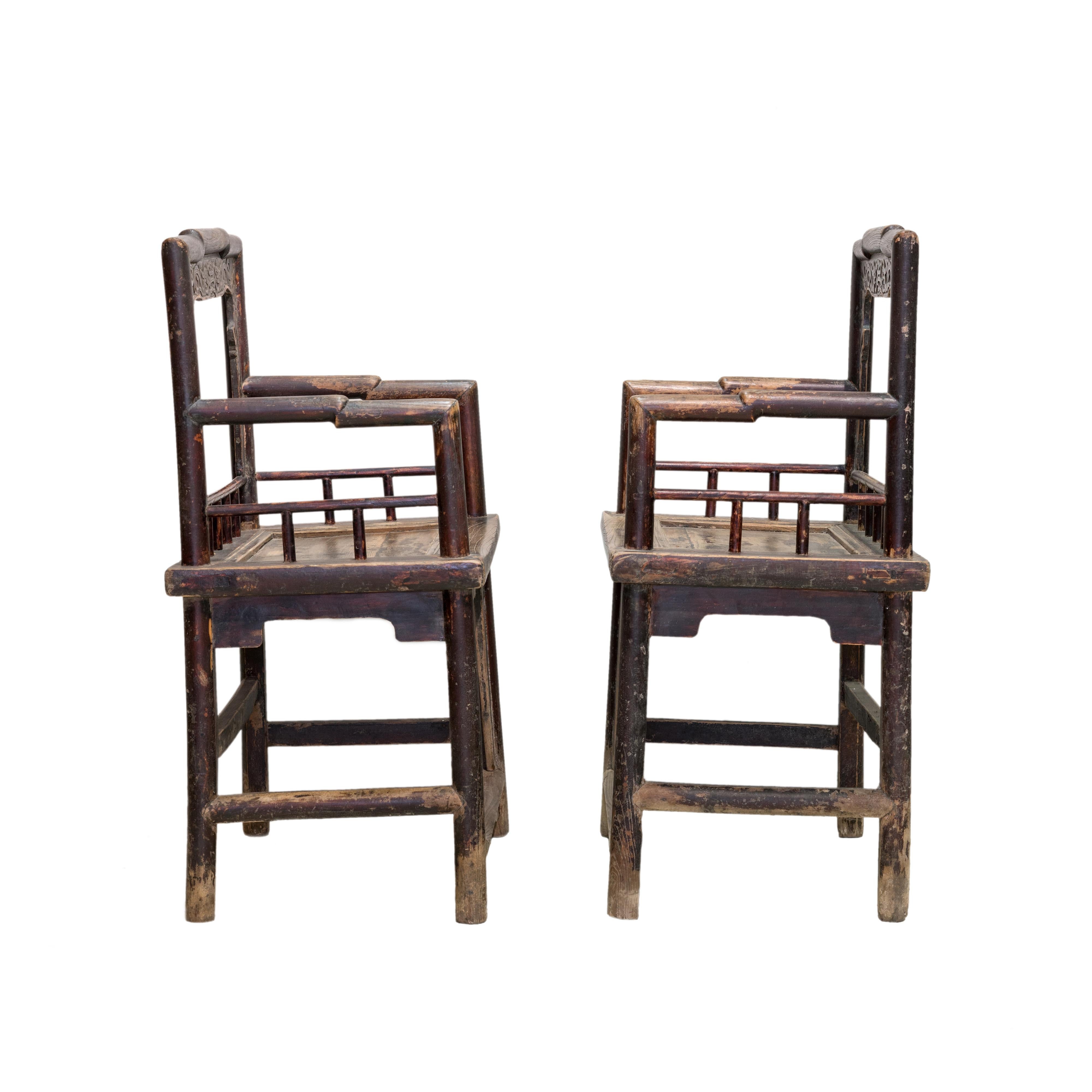 A pair of elmwood rose armchairs from northern China. Solid rounded framework with an interesting 