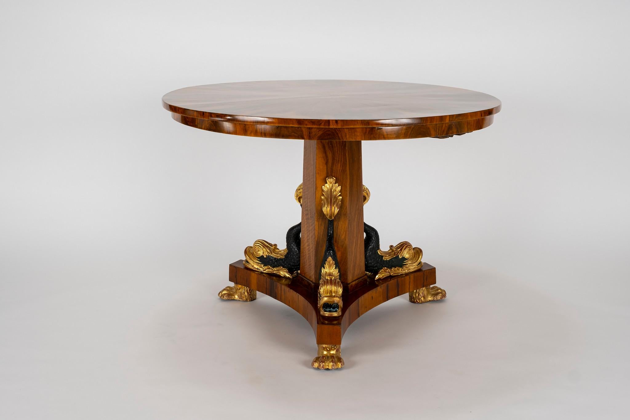 Early 20th century Empire lacquered walnut dolphin center table.