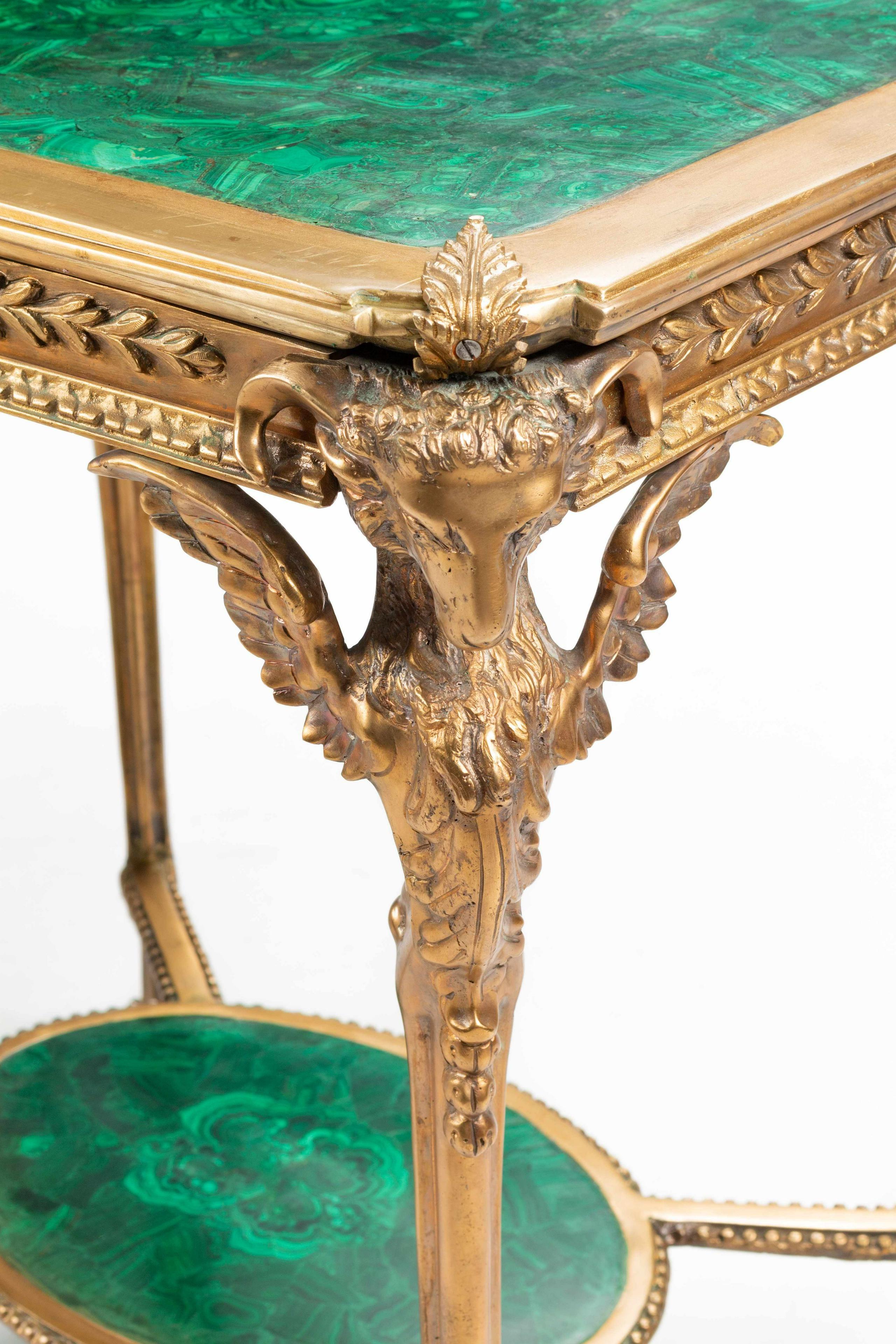 A fine pair of early 20th century Empire neoclassical style gilt bronze and malachite tables

Measures: Height 29 1/2 x width 28 1/2 x depth 20 1/4 inches.
 